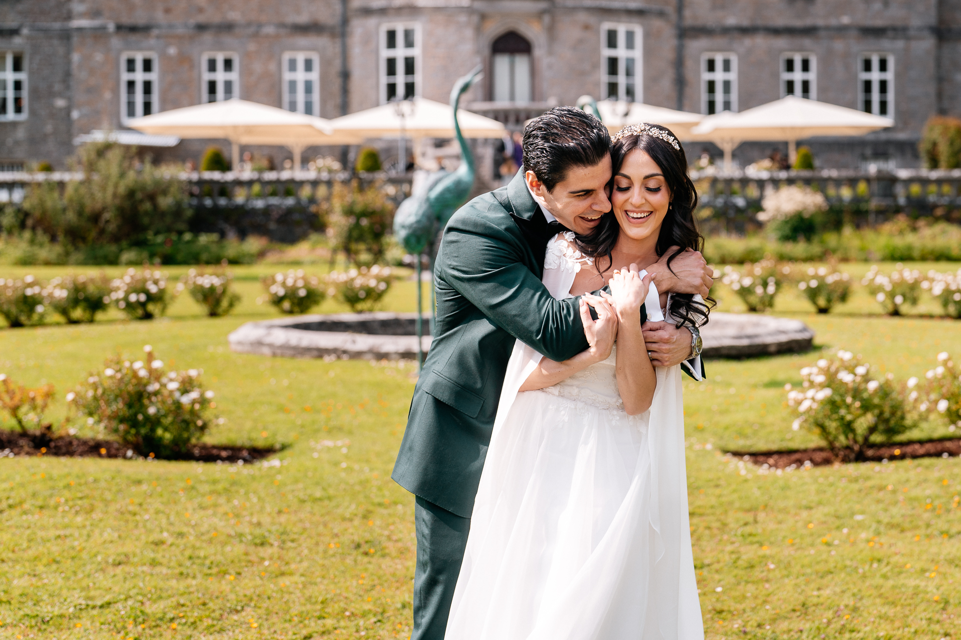 Bride and groom walking through the gardens of Markree Castle during their wedding portrait session