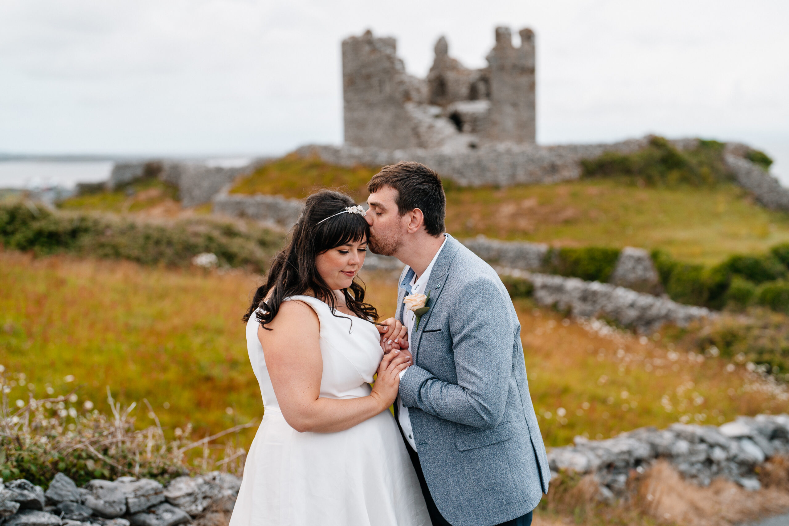 Bride and groom kiss at O'Brien's Castle – Aran Islands destination wedding on Inisheer