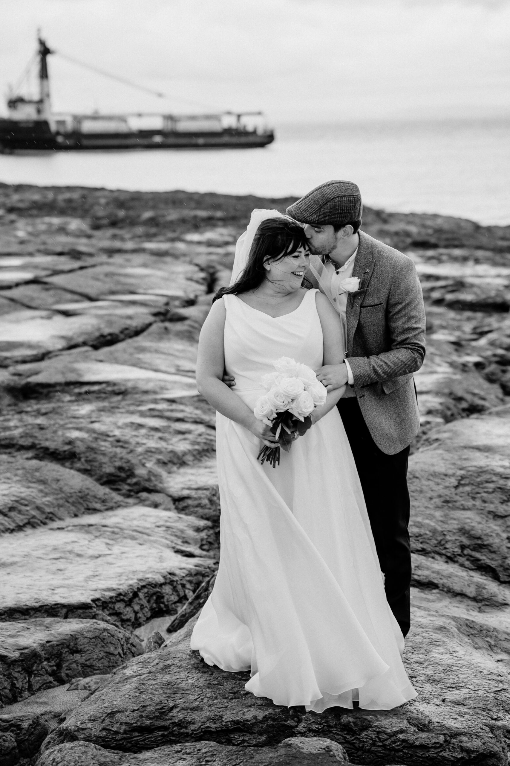 Bride and groom walking hand in hand along the beach on Inisheer – romantic wedding moment by the Atlantic shore
