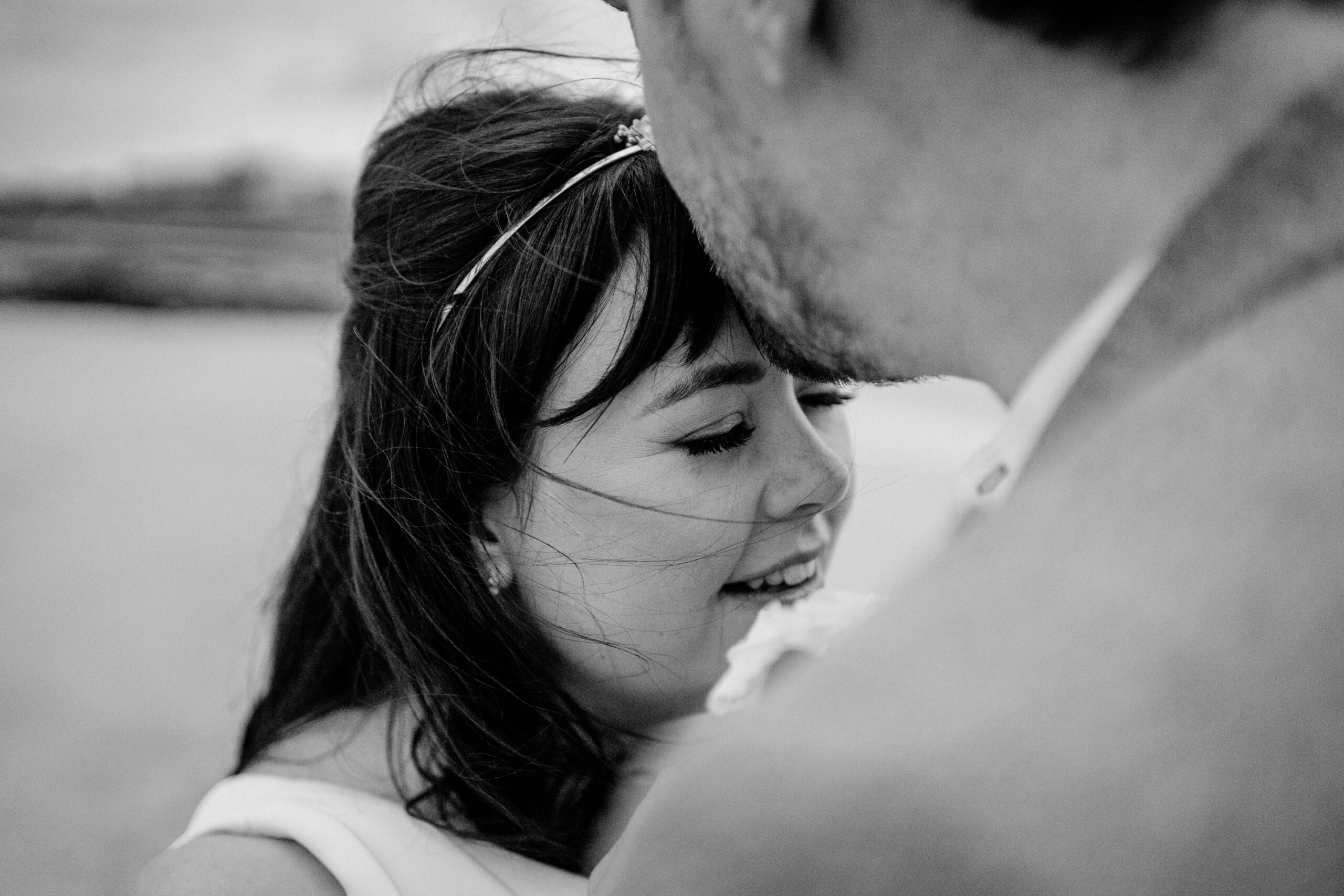 Close-up of the bride smiling with eyes closed, leaning into the groom during a beach wedding on Inisheer – Aran Islands