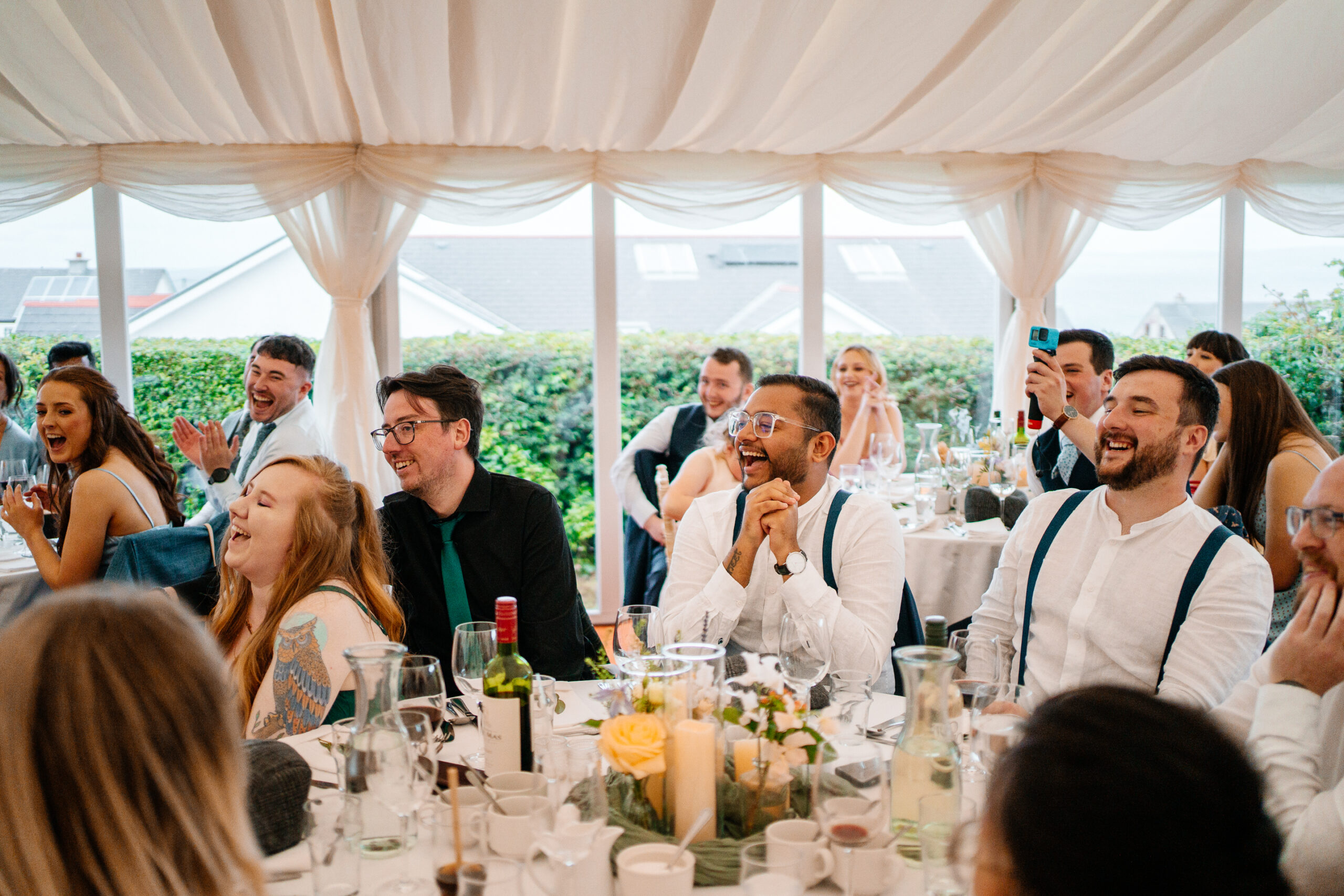 Wedding speeches during marquee reception near Markree Castle with natural light and guests’ reactions