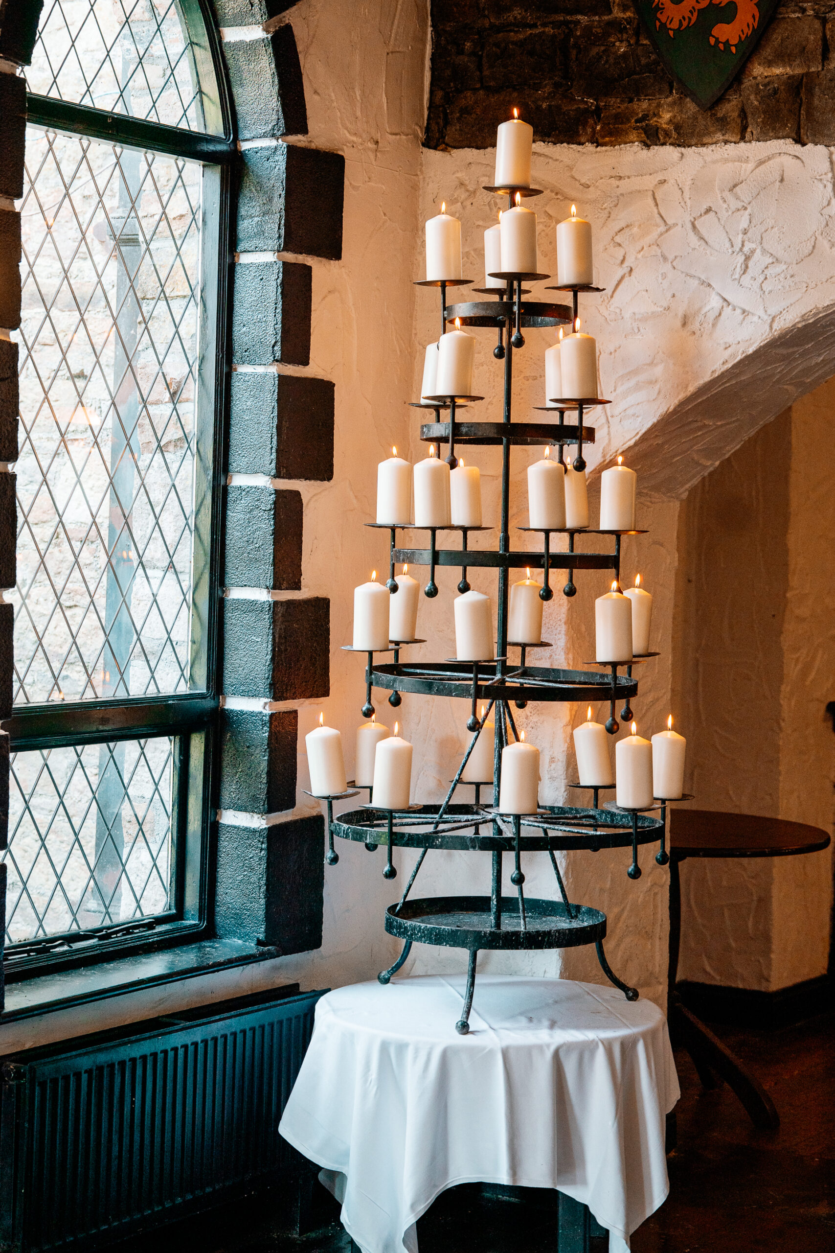 Cozy dining room and library bar setup at Kinnity Castle Hotel with bookshelves, open fire, rustic florals, and elegant details.