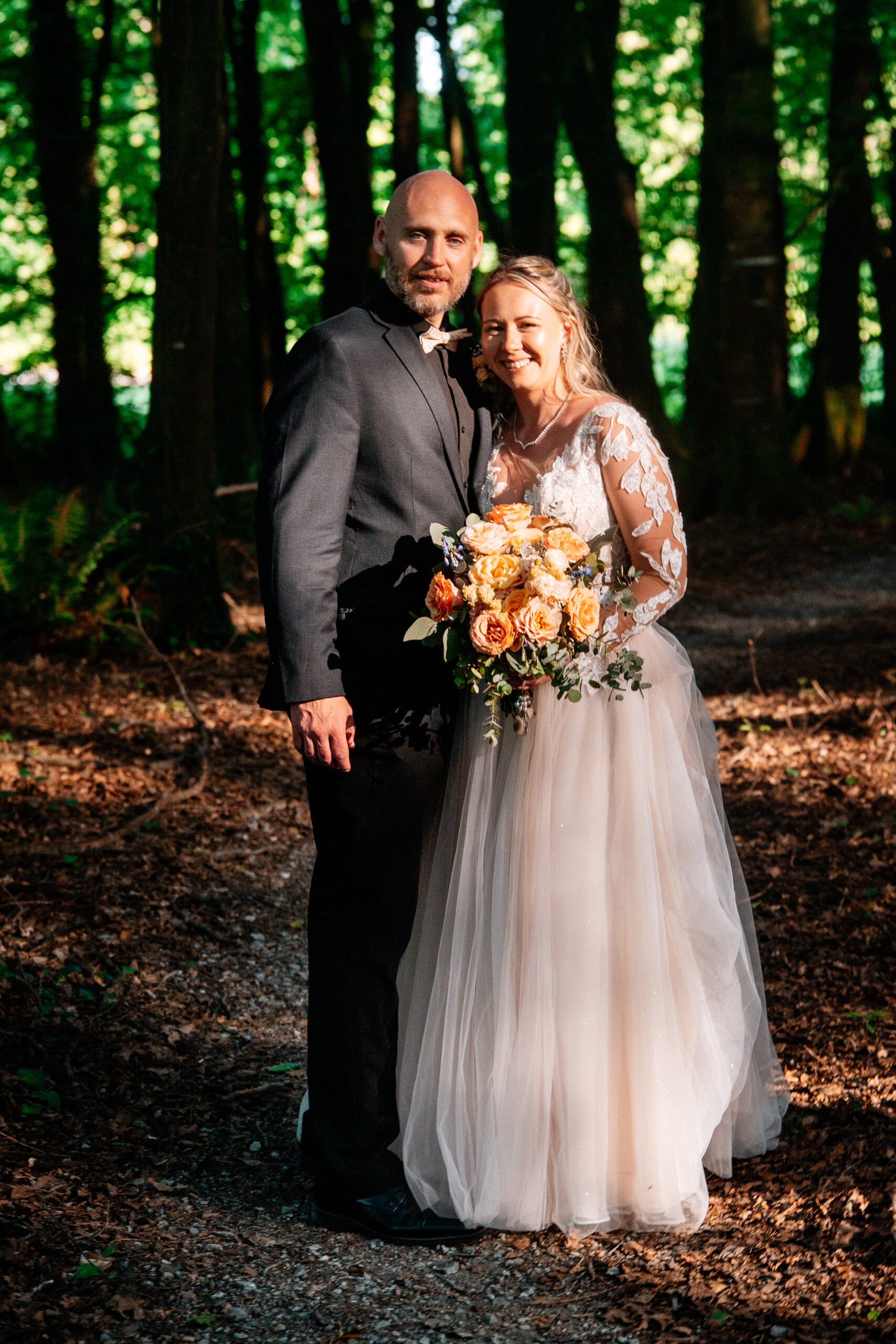 Bride and groom walking across Kinnitty Suspension Bridge and forest paths at sunset near Kinnitty Castle Hotel.
