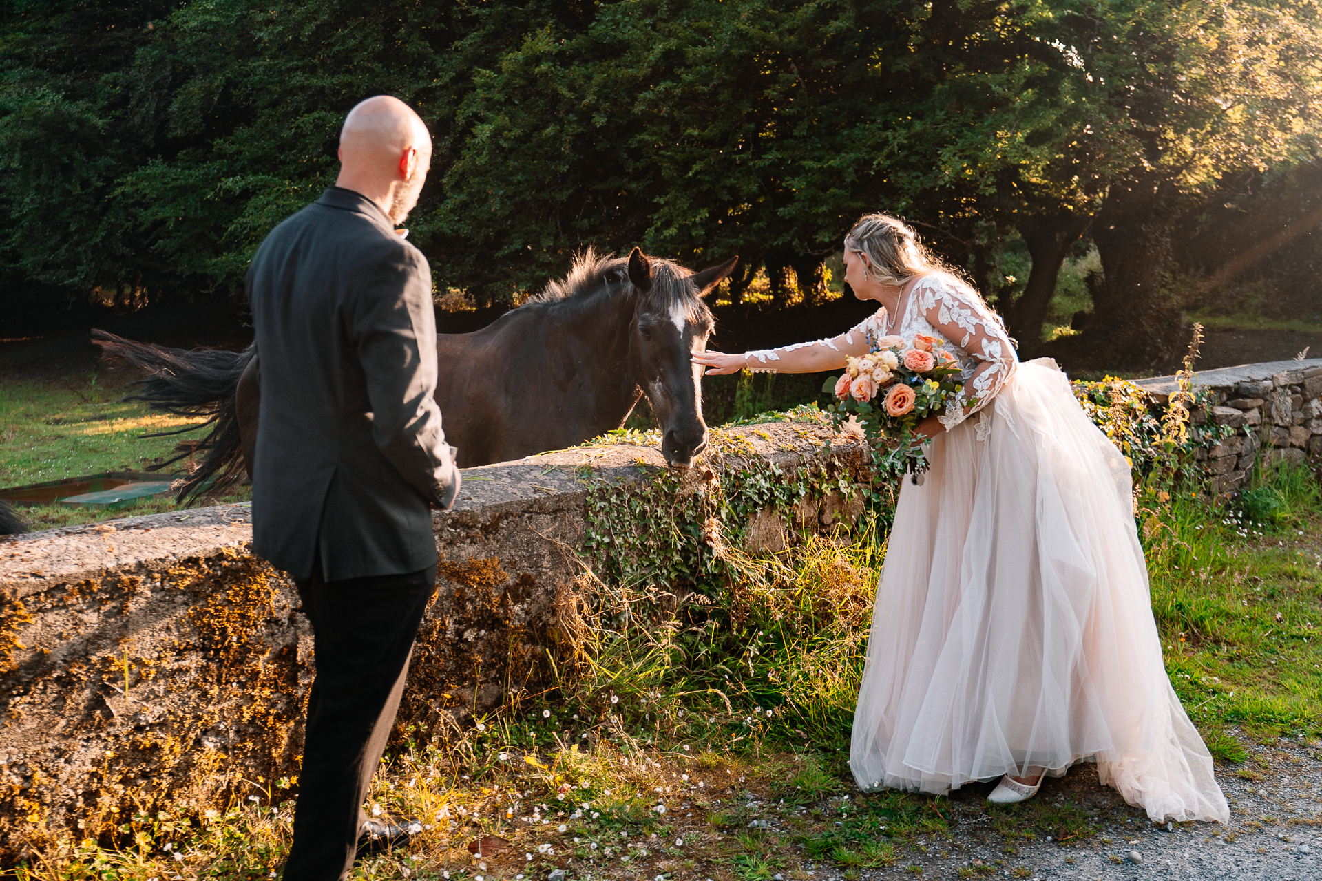 Bride and groom walking across Kinnitty Suspension Bridge and forest paths at sunset near Kinnitty Castle Hotel.