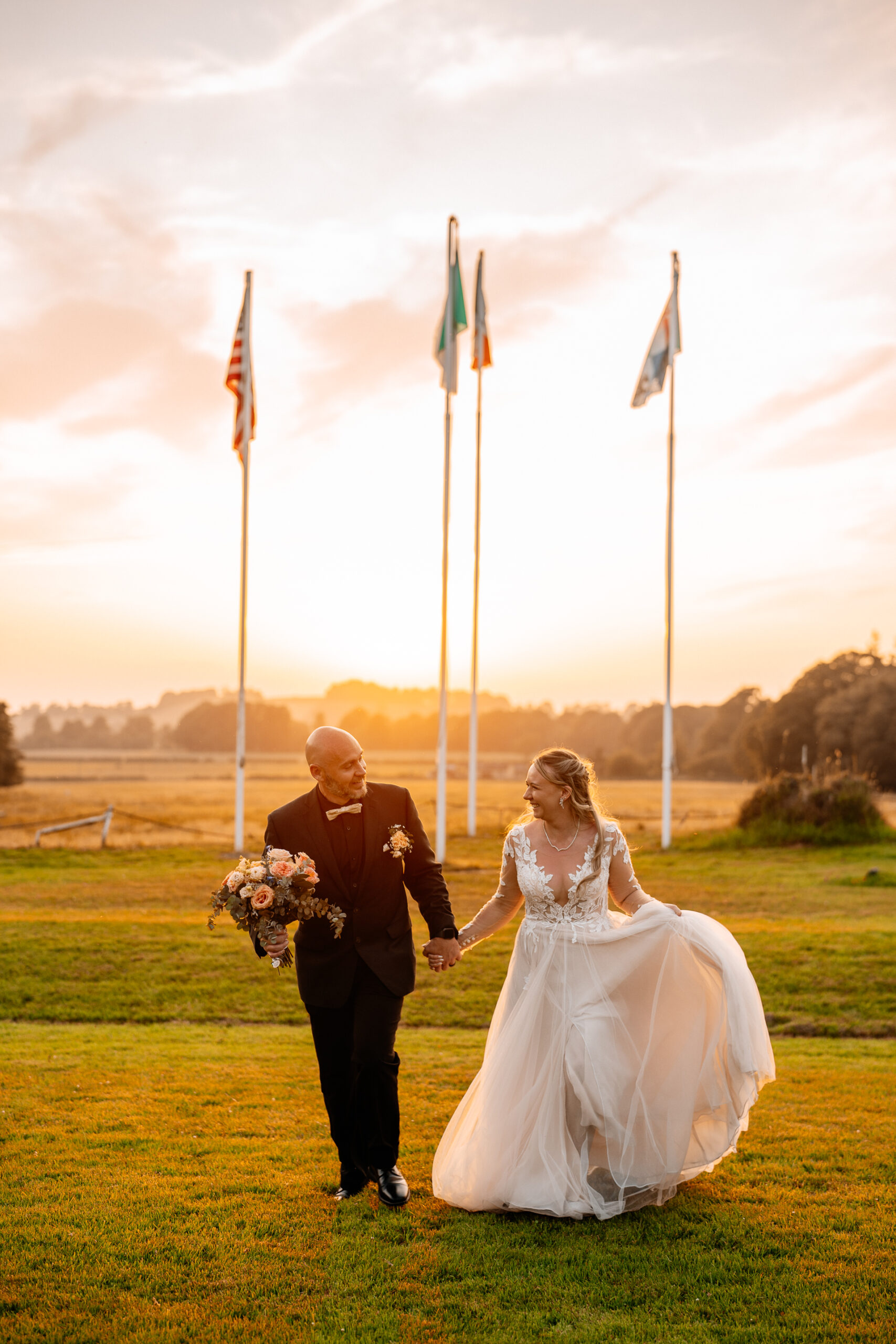 Bride and groom walking across Kinnitty Suspension Bridge and forest paths at sunset near Kinnitty Castle Hotel.