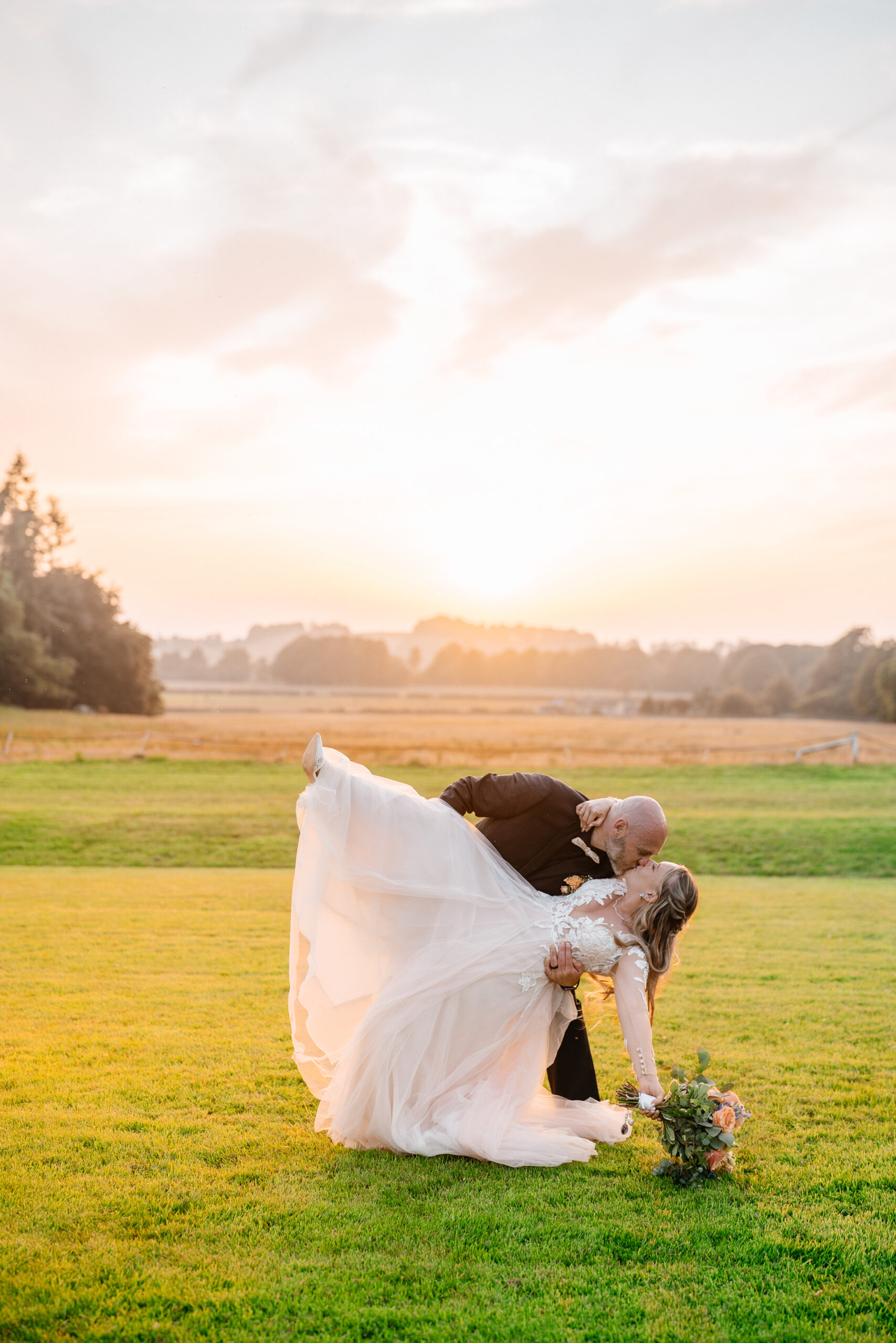 Bride and groom walking across Kinnitty Suspension Bridge and forest paths at sunset near Kinnitty Castle Hotel.