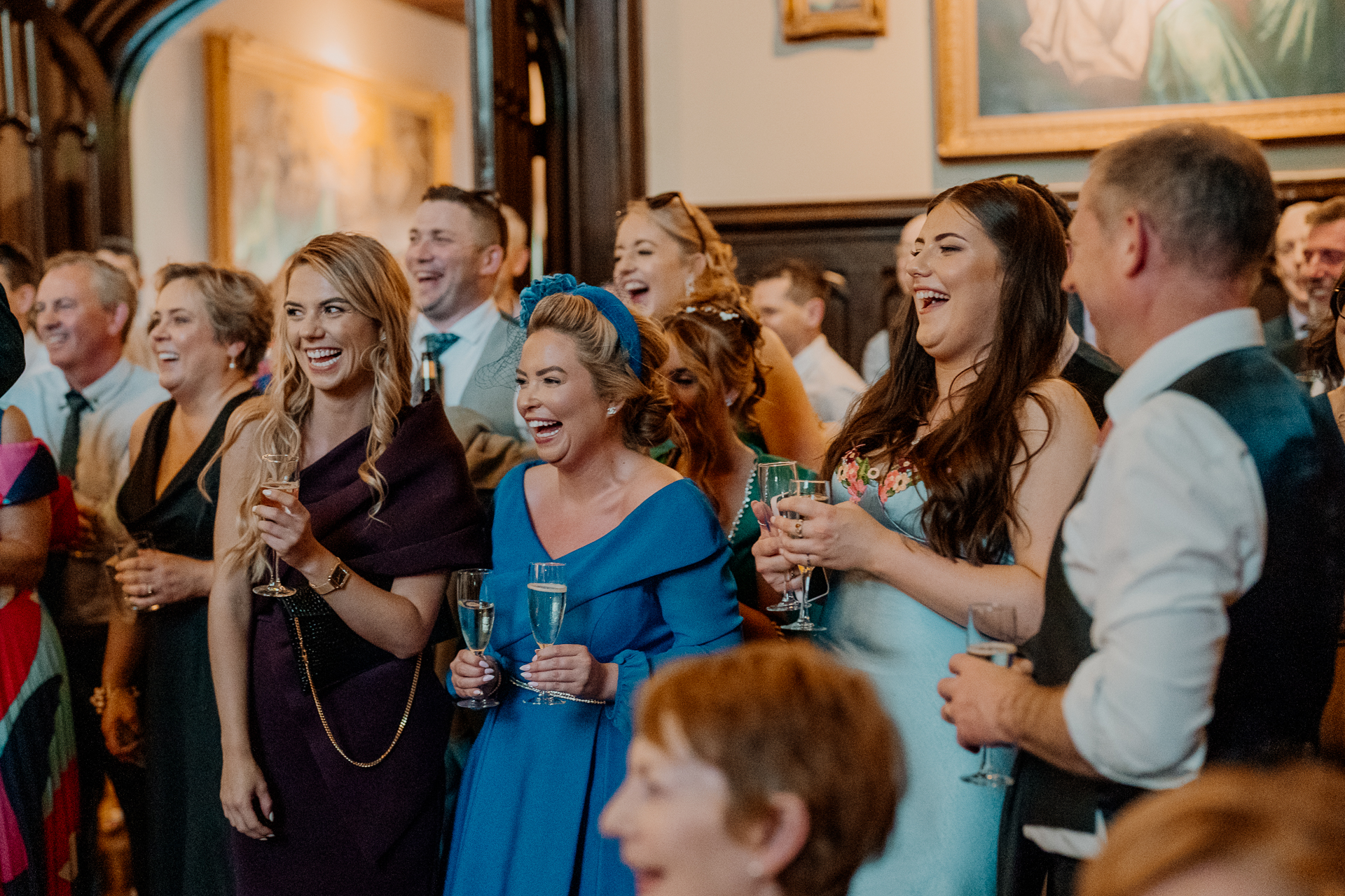 Wedding guests toasting and laughing during a best man speech at Markree Castle

