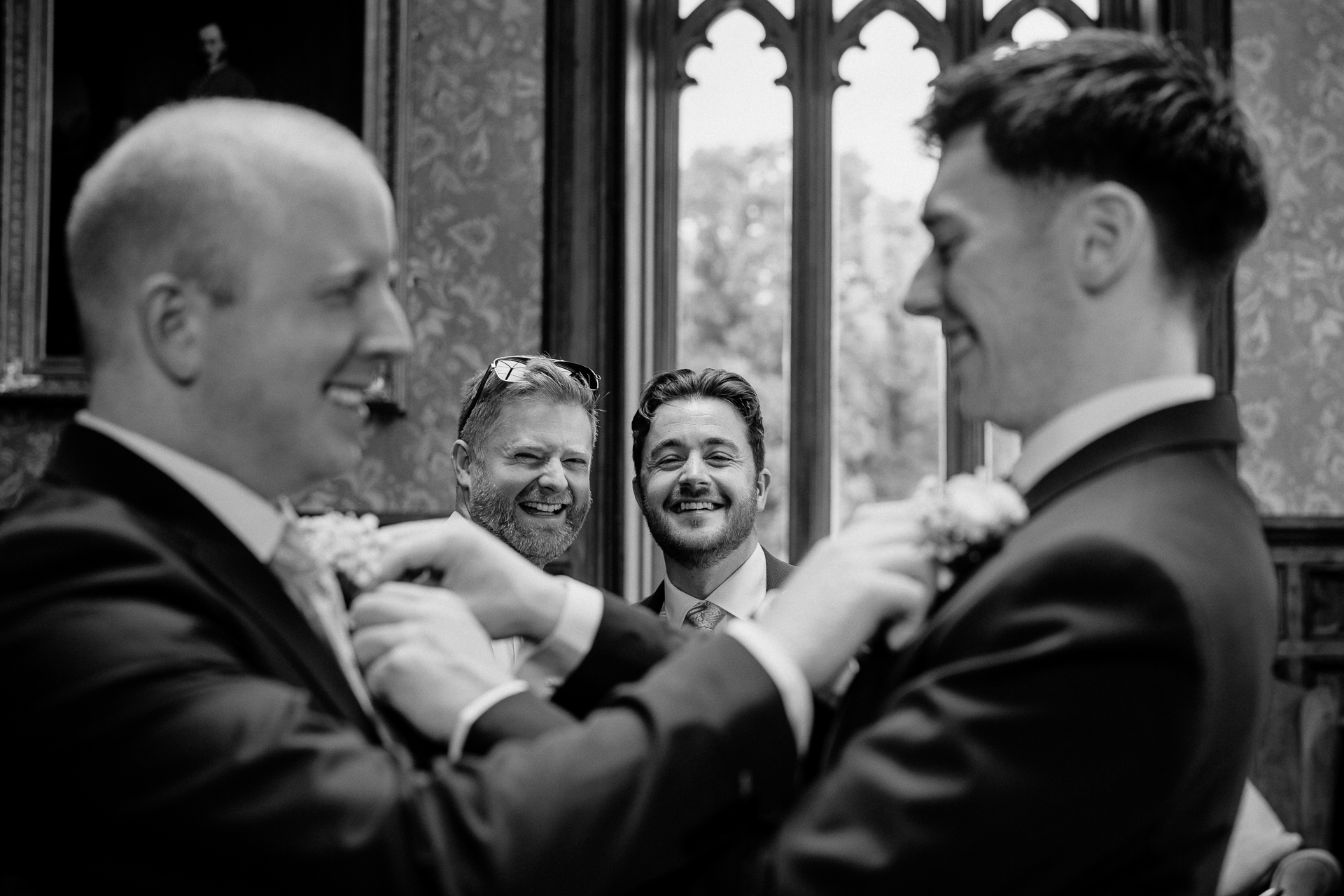 Groom smiling with groomsmen at Markree Castle before the ceremony – black and white photo

