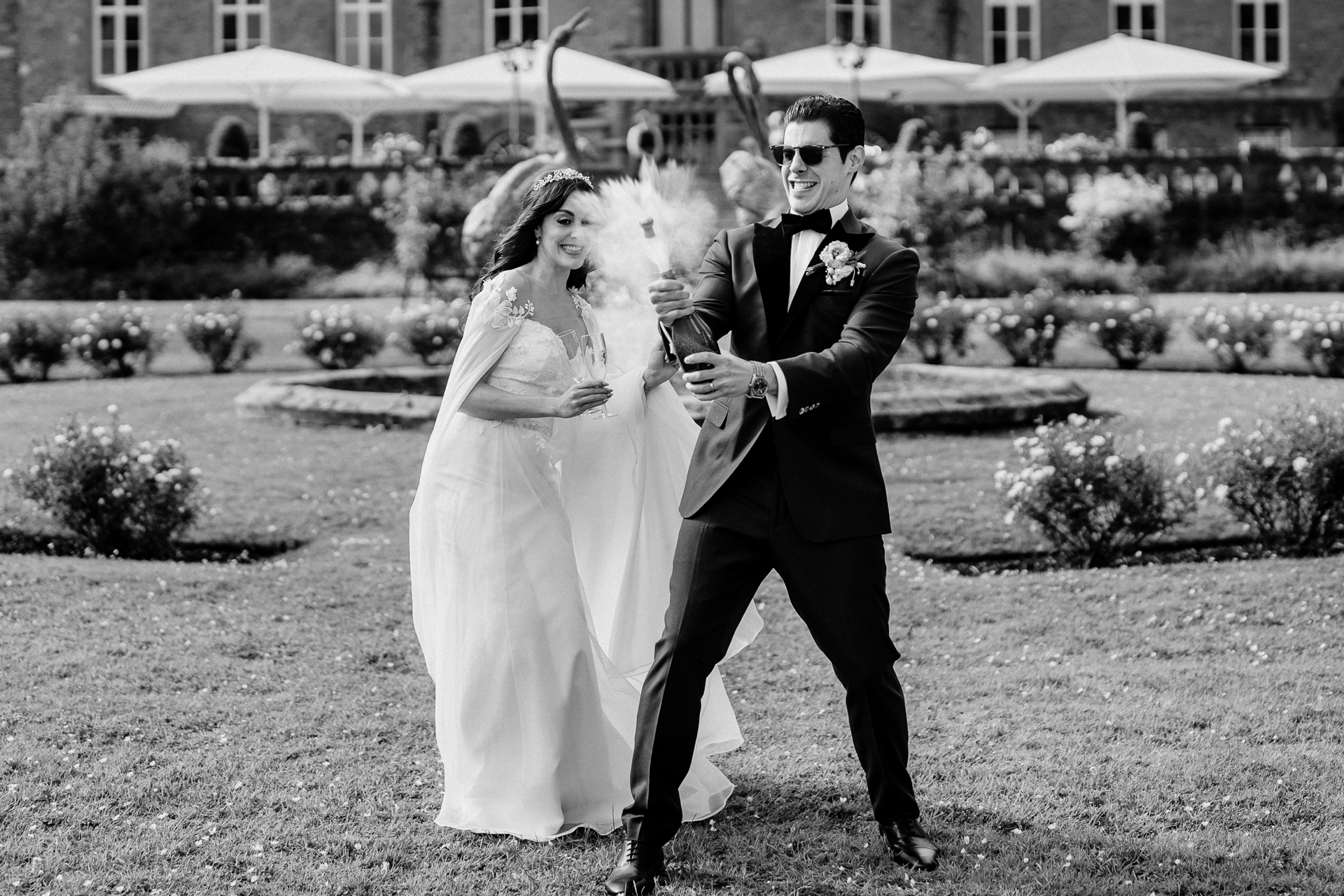 Bride and groom walking through the gardens of Markree Castle, black and white photo

