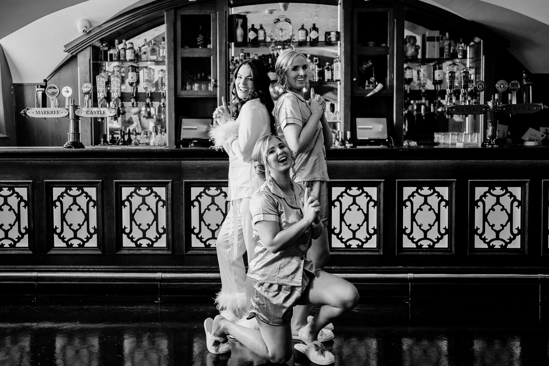 Bride and groom kiss in front of the vintage bar at Markree Castle during their wedding day


