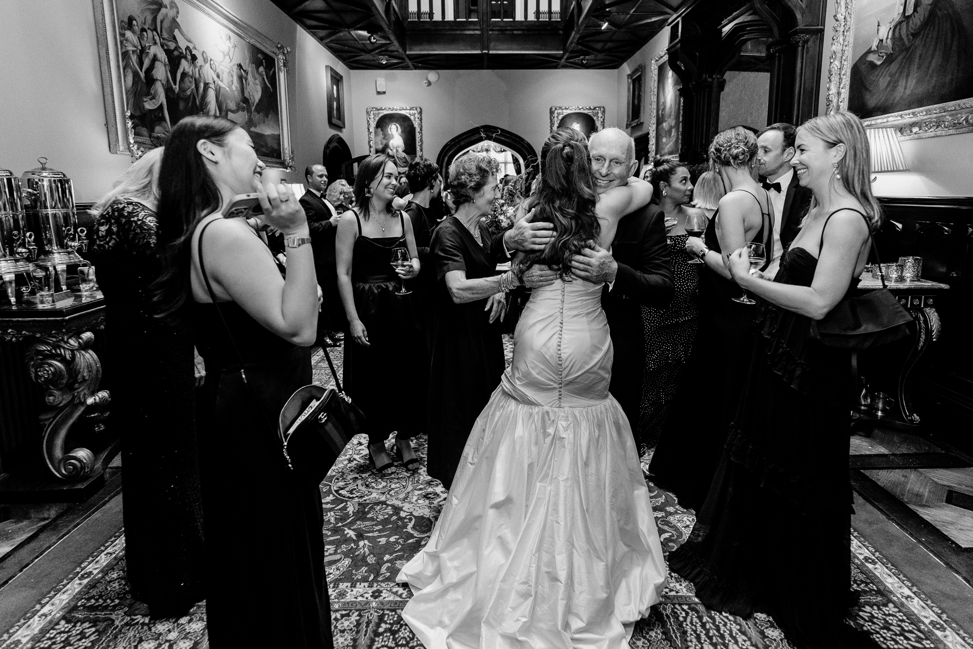 Guests enjoying the wedding reception and speeches at Markree Castle, with Irish Wolfhound Fionn joining the celebration