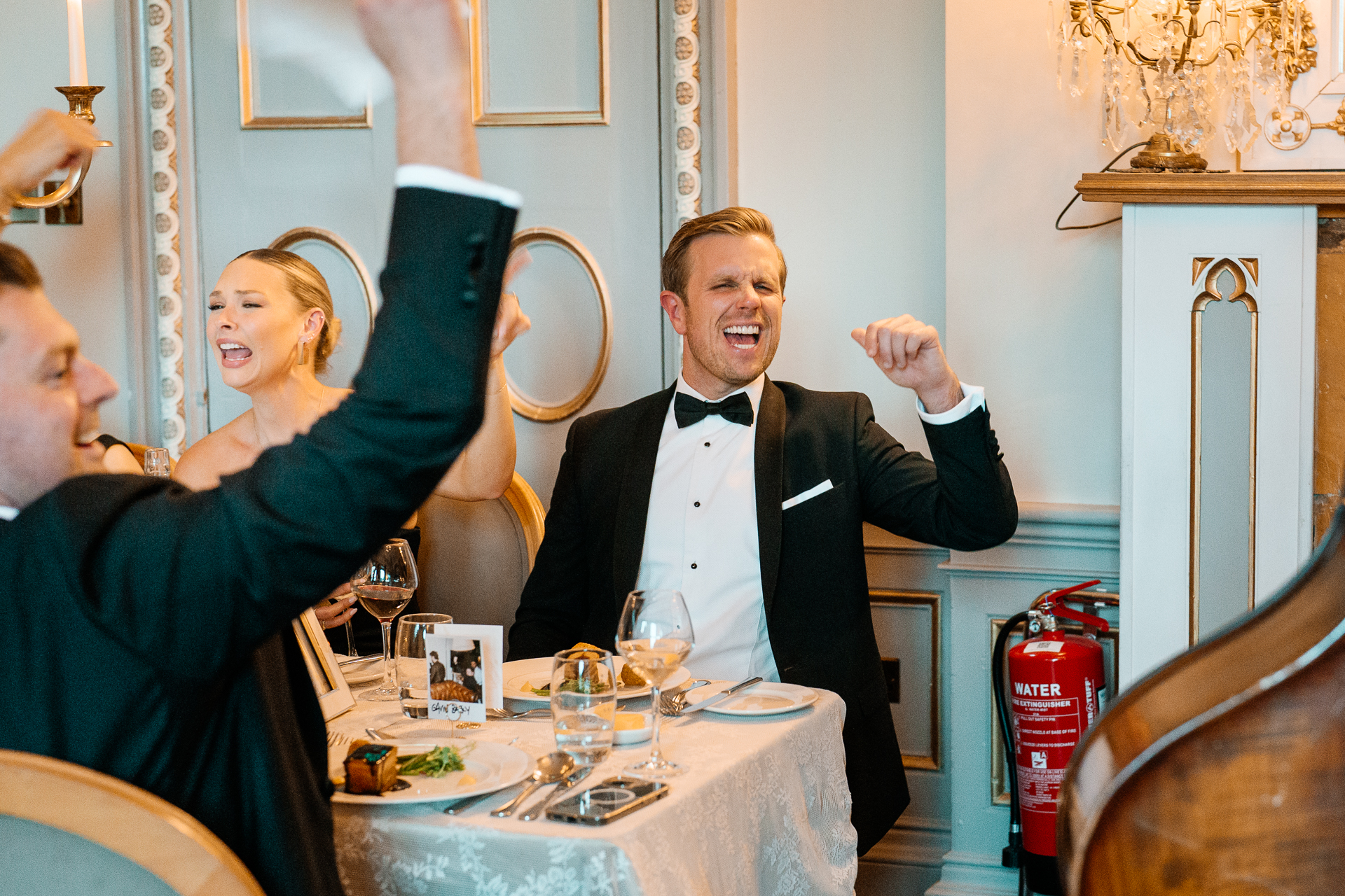 Candid wedding dinner, cake cutting, and live music at Markree Castle dining room