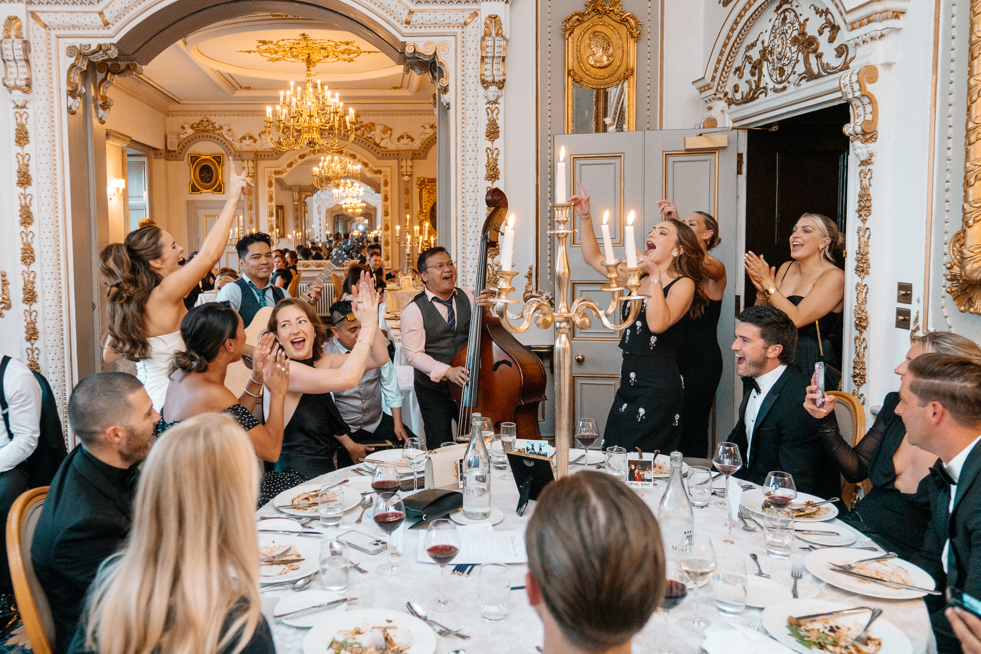 Candid wedding dinner, cake cutting, and live music at Markree Castle dining room