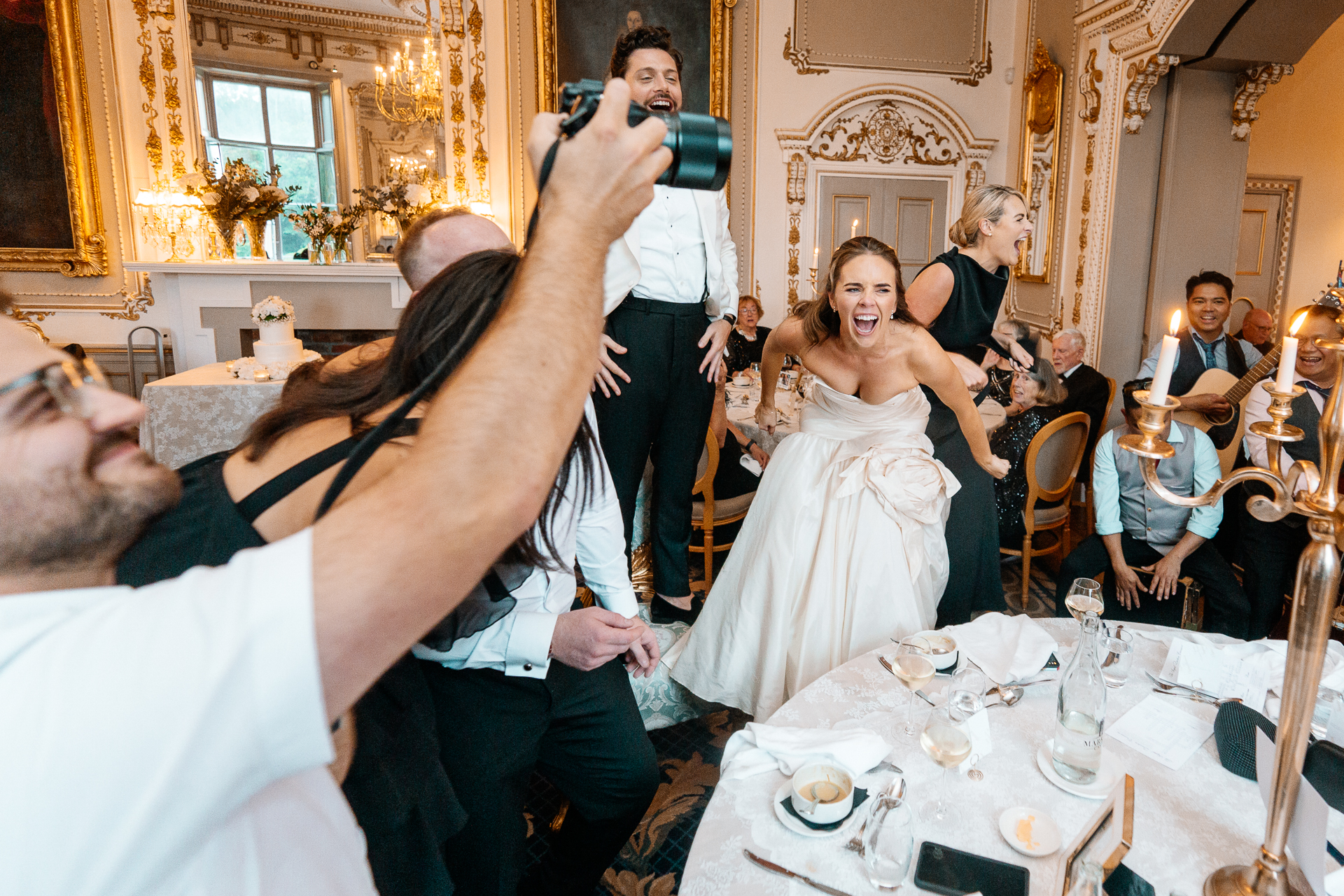 Candid wedding dinner, cake cutting, and live music at Markree Castle dining room