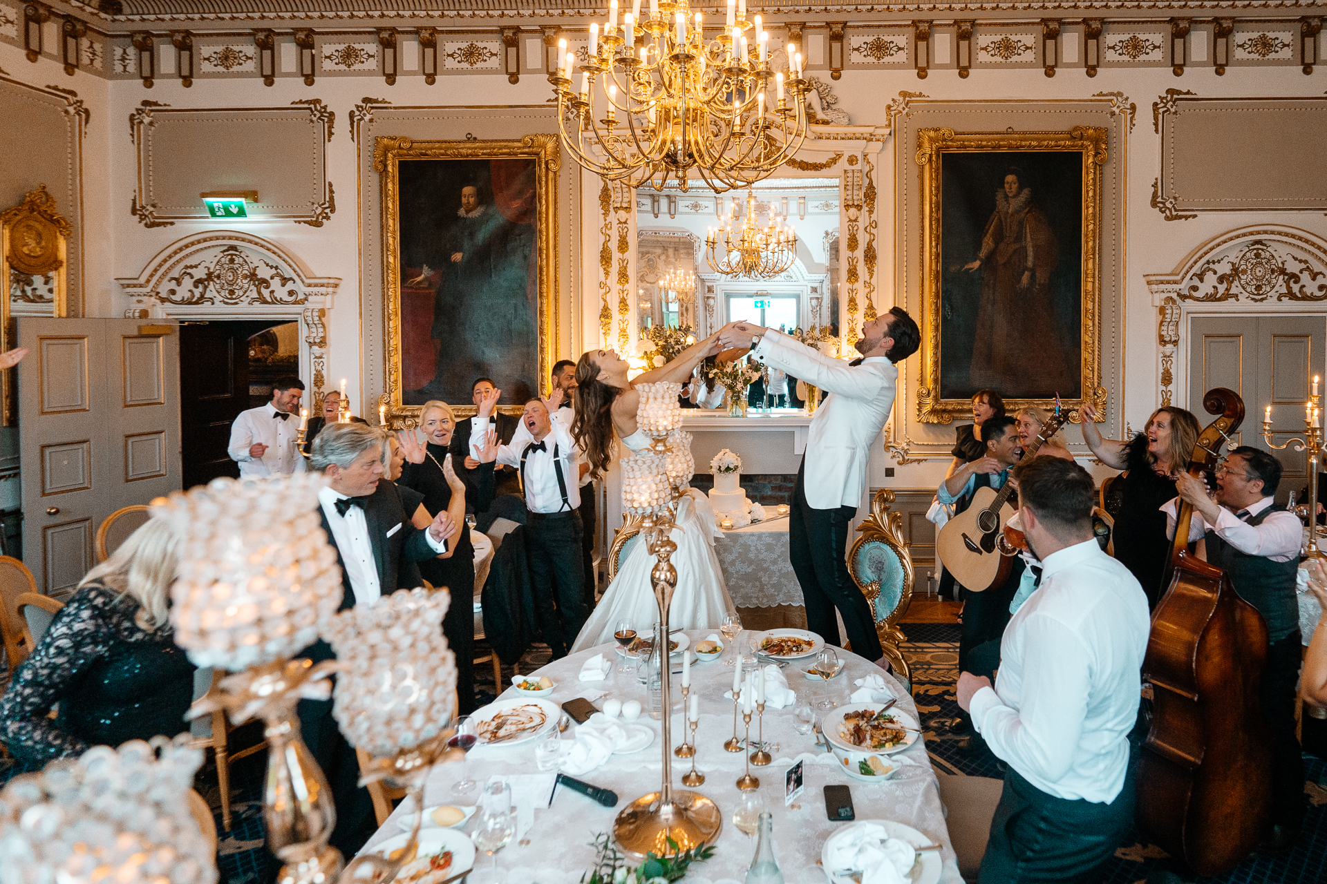 Candid wedding dinner, cake cutting, and live music at Markree Castle dining room