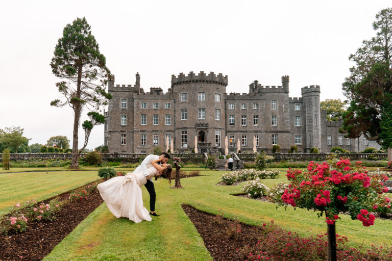 Bride and groom kissing in the garden of Markree Castle, Ireland – romantic wedding moment