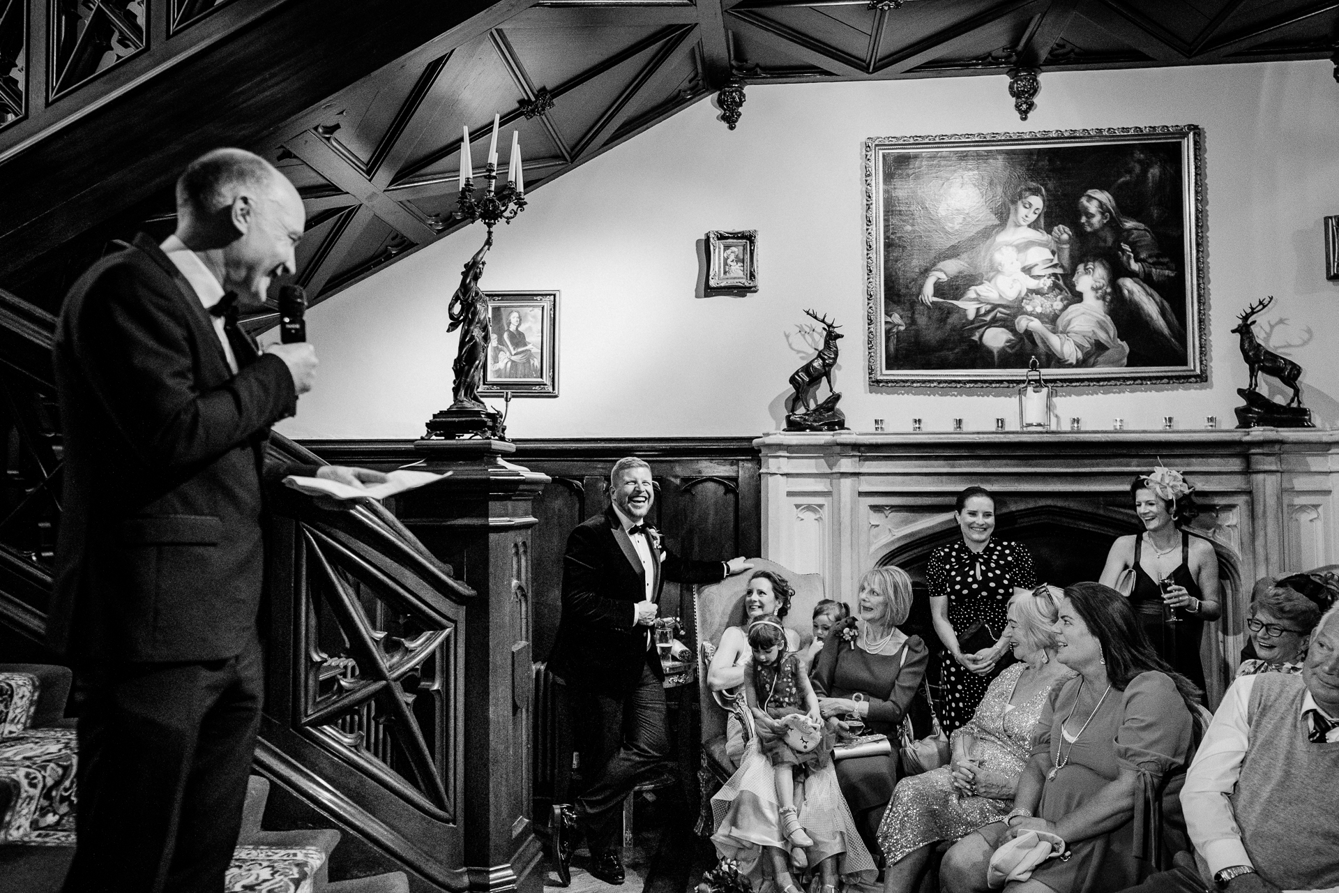 Black and white photo of a wedding speech in the dining room at Markree Castle

