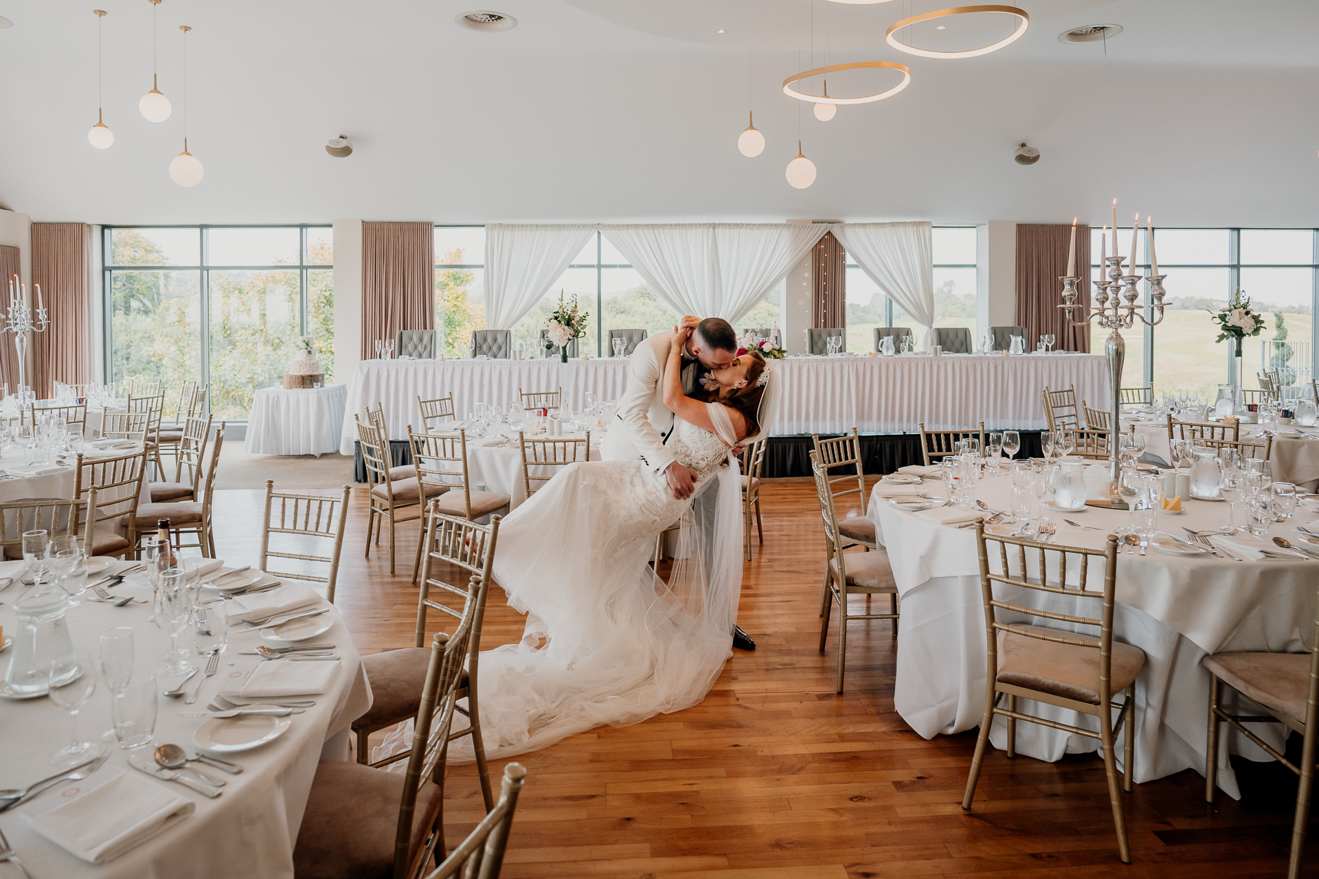 Castle Dargan wedding reception dining room with panoramic views Bride and groom portraits inside Castle Dargan Estate dining room Elegant Castle Dargan wedding dining room setup in Sligo