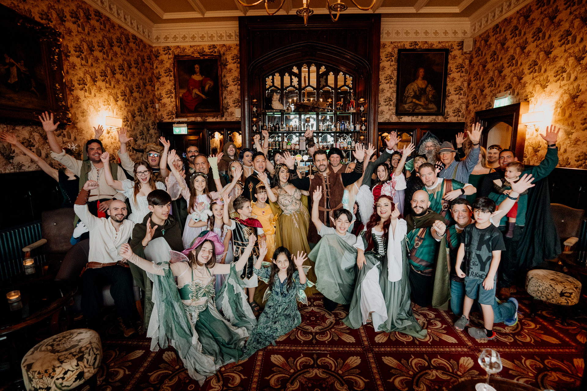 Group photo of guests in fantasy-themed costumes during a rehearsal dinner at Markree Castle, Sligo, Ireland
