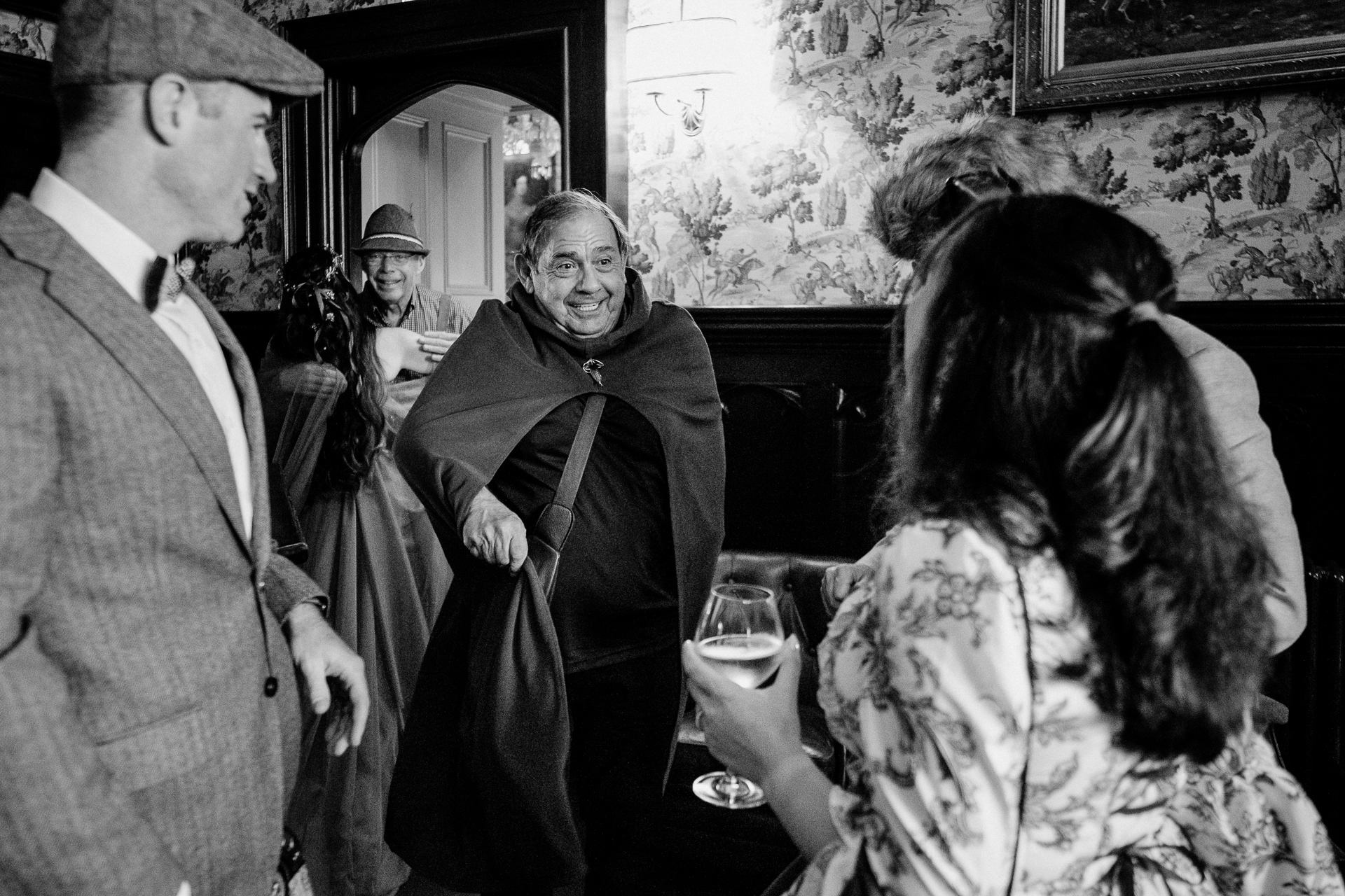 Candid moment of wedding guests in fantasy costumes during rehearsal dinner at Markree Castle, Sligo, Ireland
