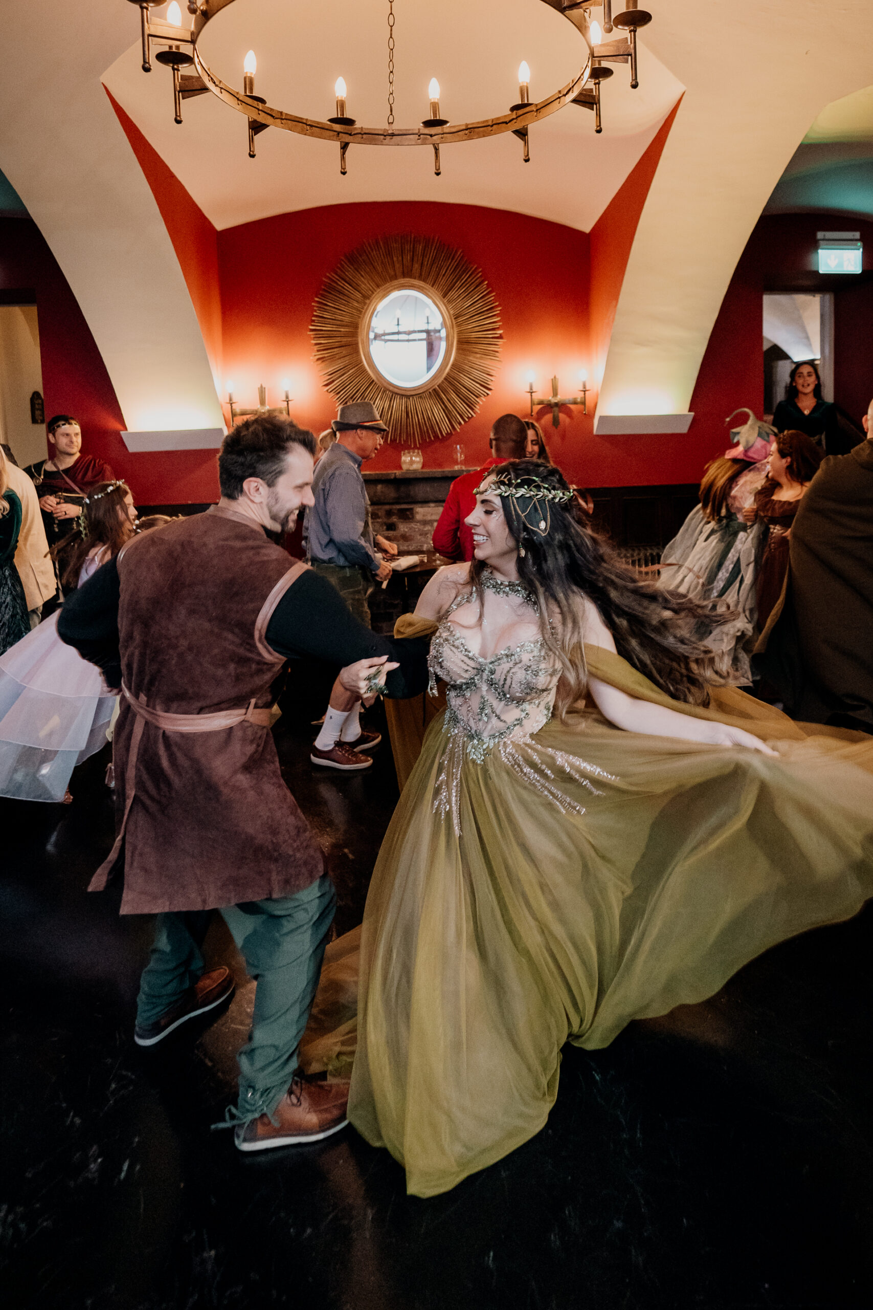 Guests mingling in fantasy-inspired costumes during a rehearsal dinner at Markree Castle in Sligo, Ireland