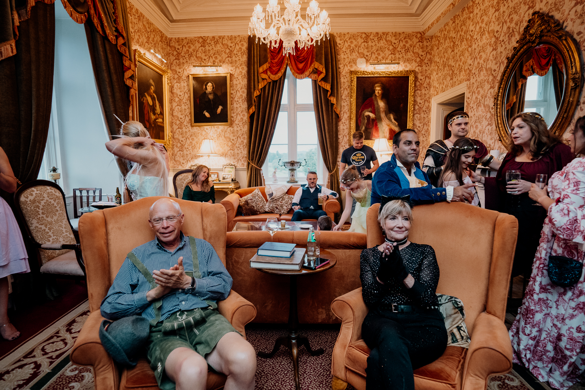Guests in elaborate fantasy costumes gathered in the grand dining room of Markree Castle during a rehearsal dinner in Sligo, Ireland
