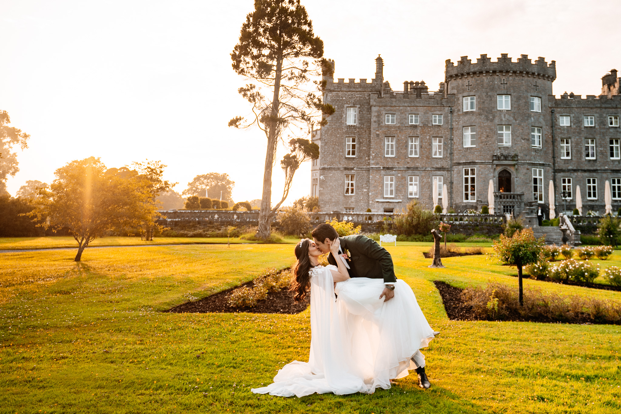 Couple during golden hour wedding photos in front of Markree Castle
