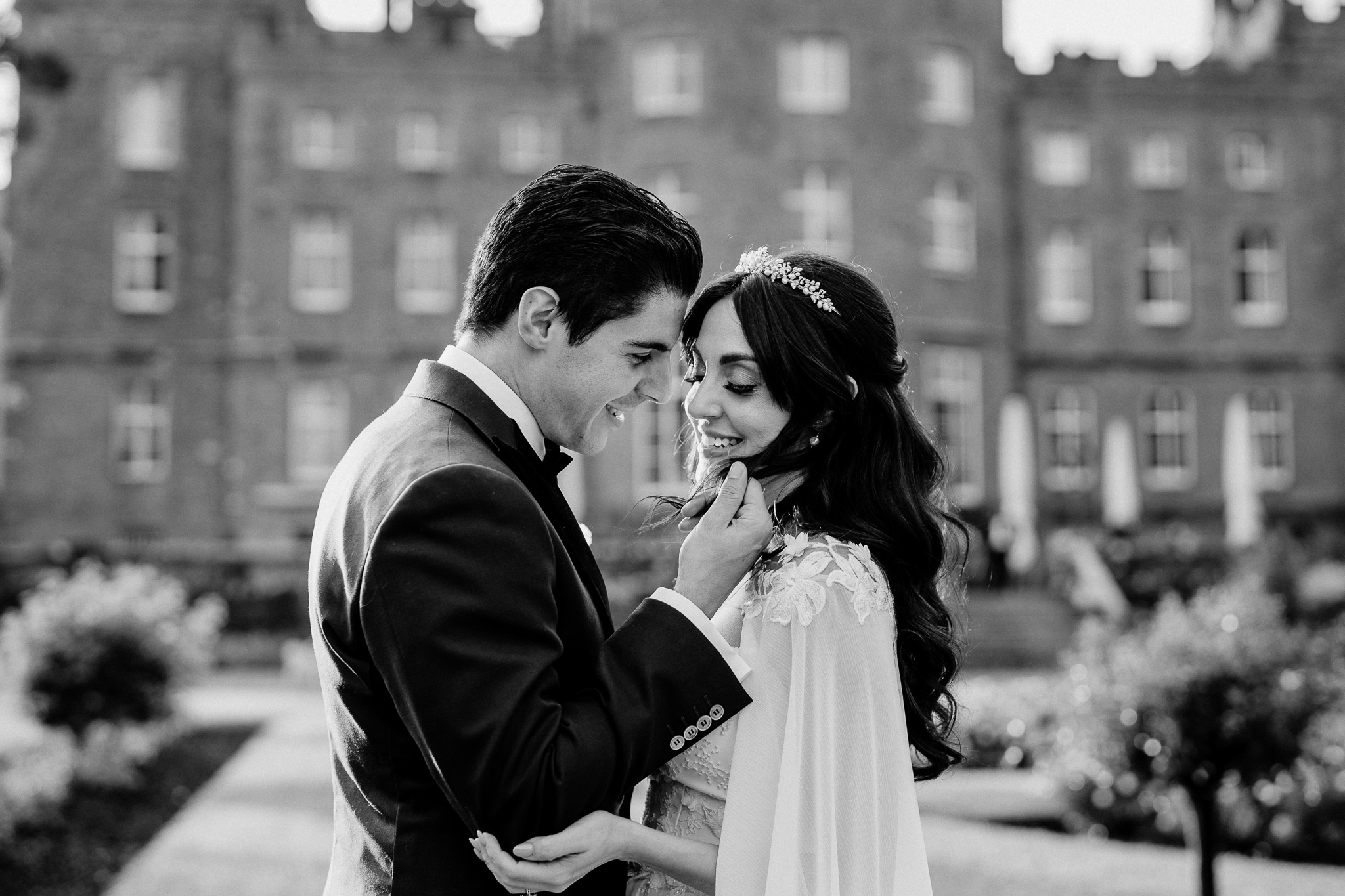 Black and white bride and groom portrait with Markree Castle behind them