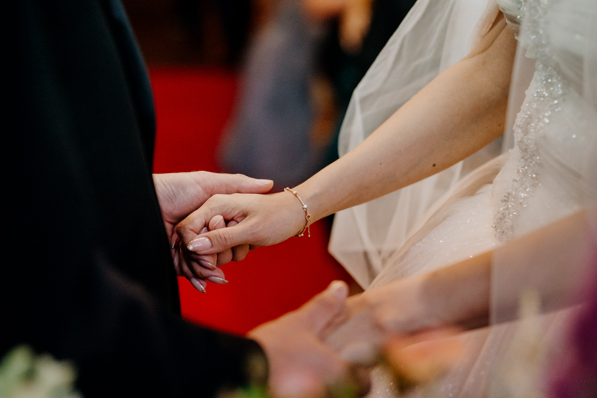 Bride and groom holding hands during their wedding ceremony in the chapel at Markree Castle