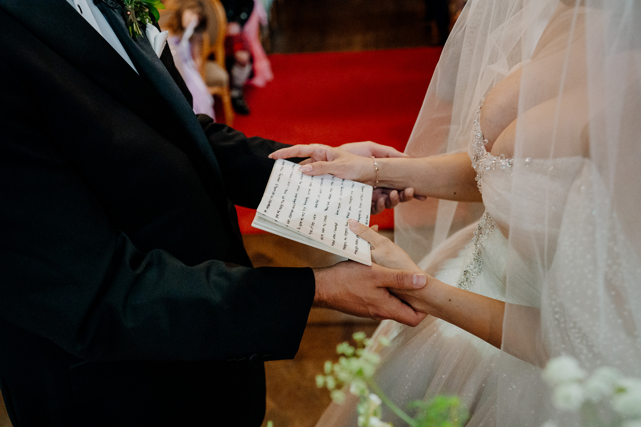 Bride and groom holding hands while exchanging vows at Markree Castle