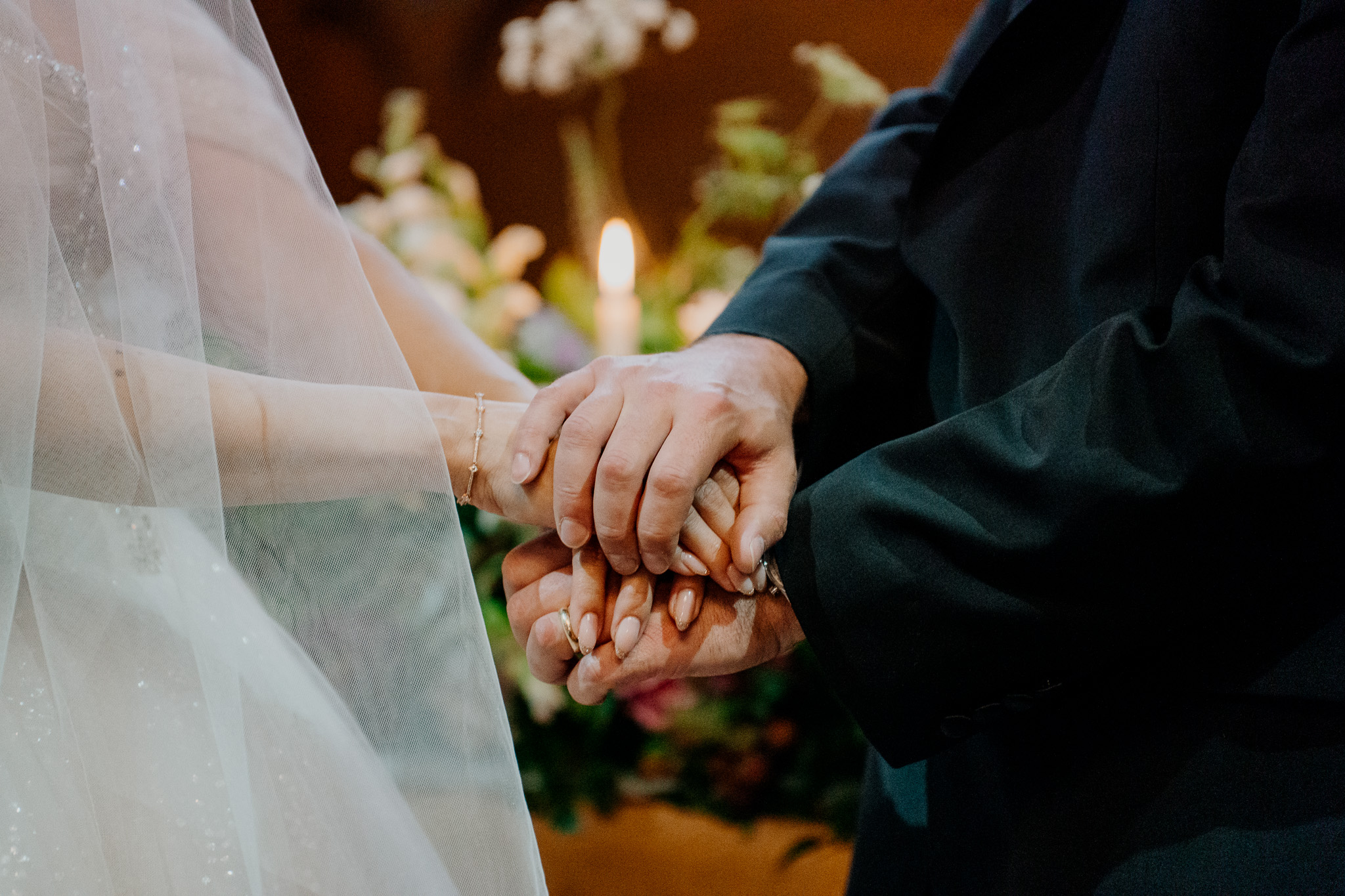 Bride and groom holding hands during their Markree Castle chapel wedding ceremony