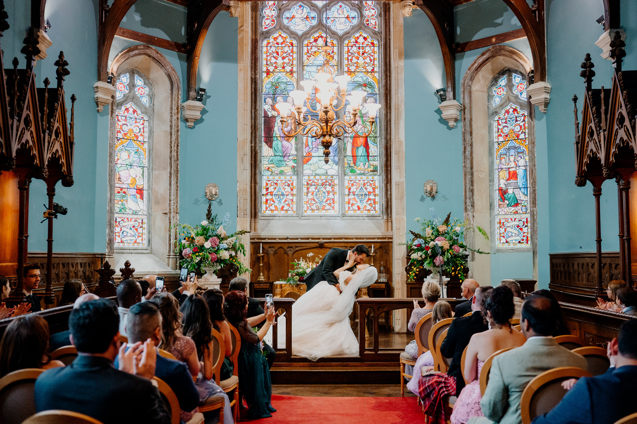 Markree Castle chapel interior with stained glass window during a wedding ceremony