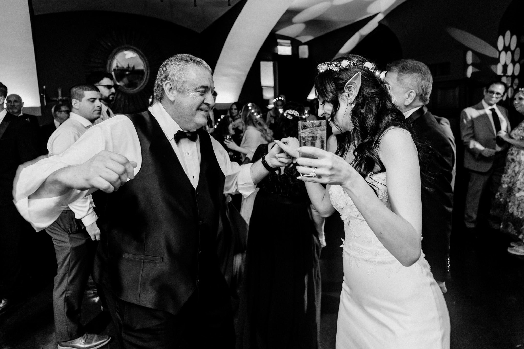 Candid black and white photo of wedding guests dancing at Markree Castle