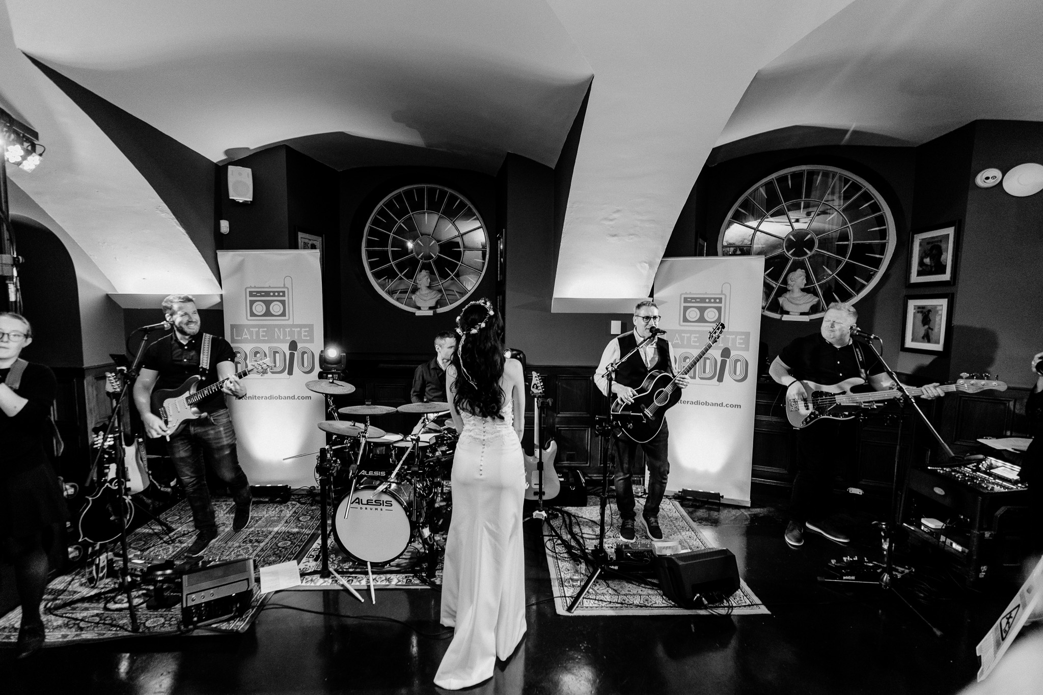 Black and white photo of a bride throwing her wedding bouquet at Markree Castle