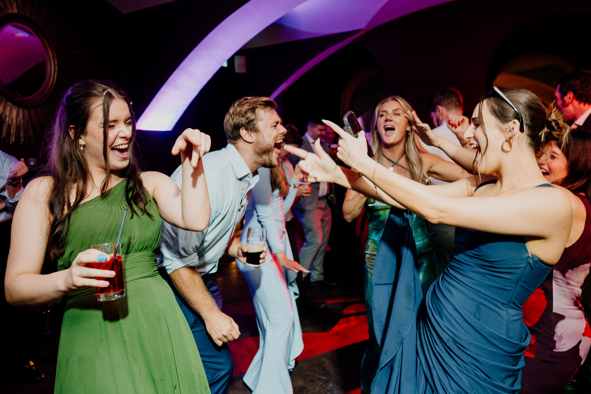 Wedding guests dancing with their hands in the air at Markree Castle