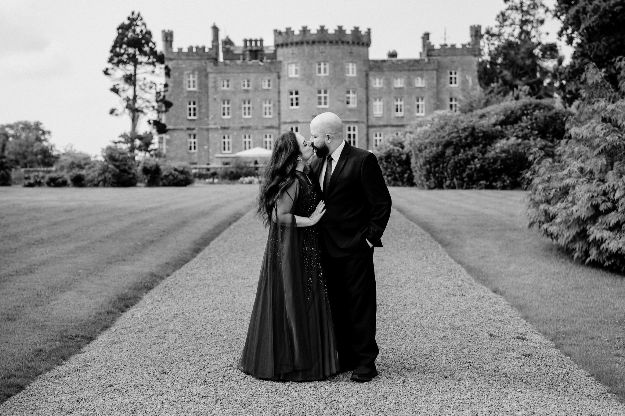 Black and white portrait of a wedding guest with Markree Castle in the background