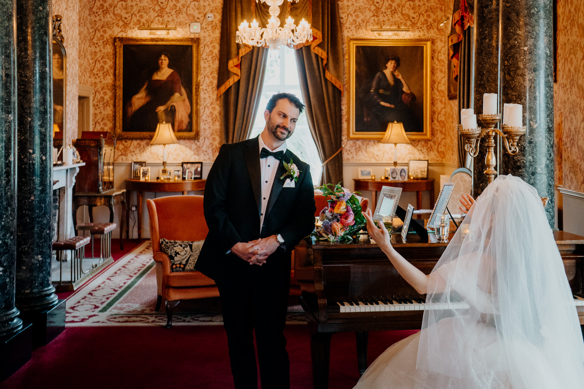 Groom wedding portrait by the piano in the Grand Hall at Markree Castle