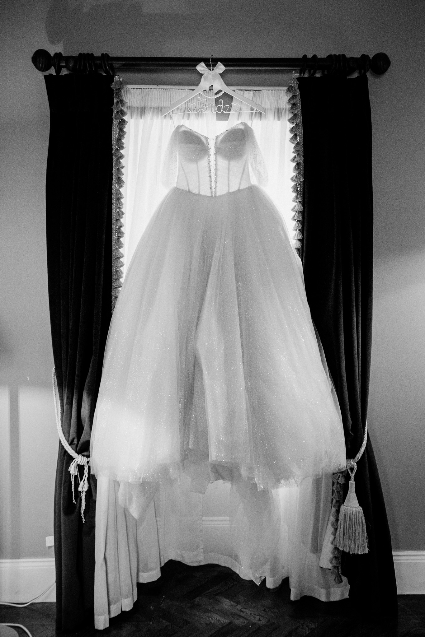 Wedding dress hanging by a window during bridal preparations at Markree Castle