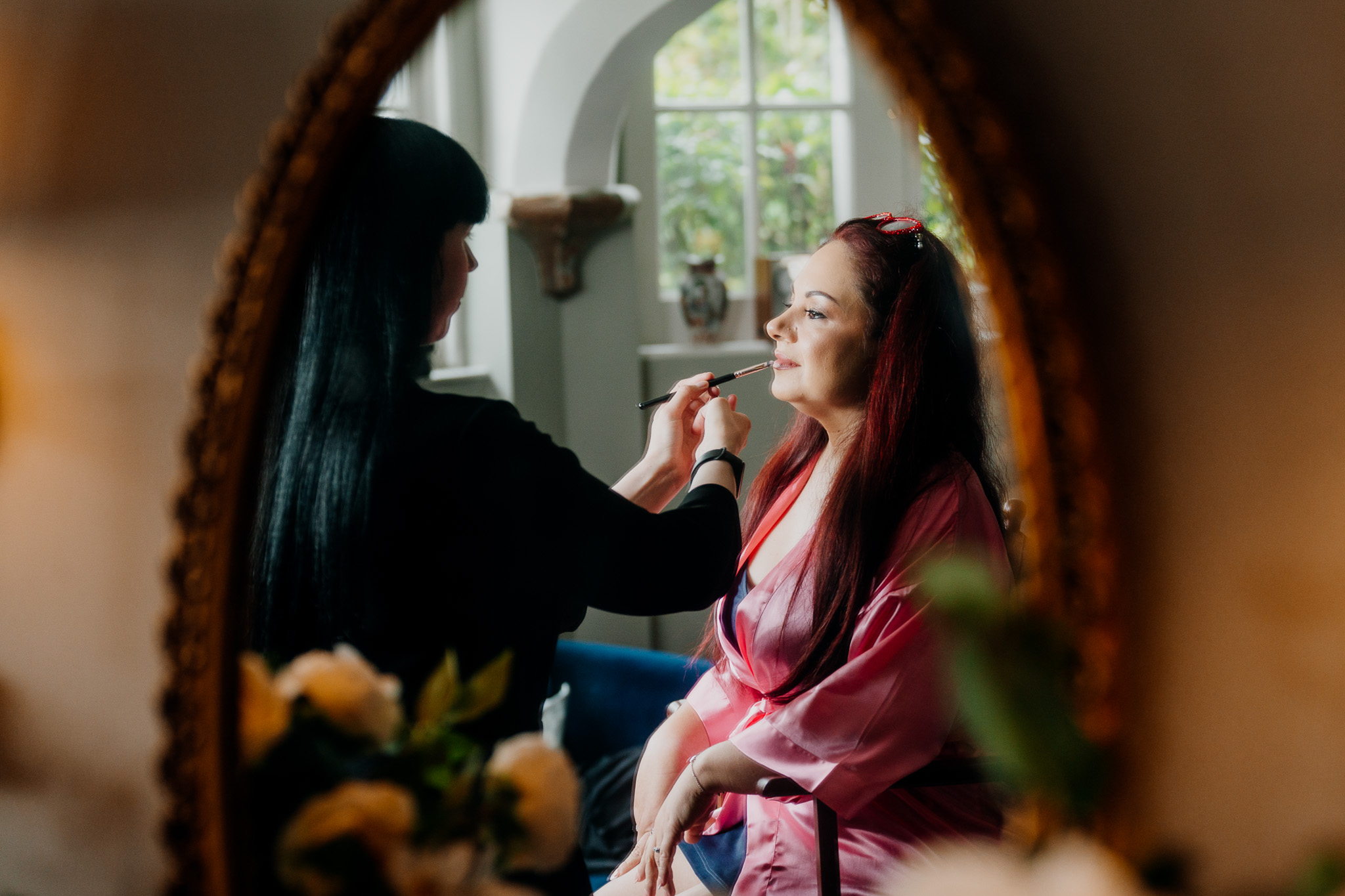 Bride getting ready by the window at Markree Castle before her wedding