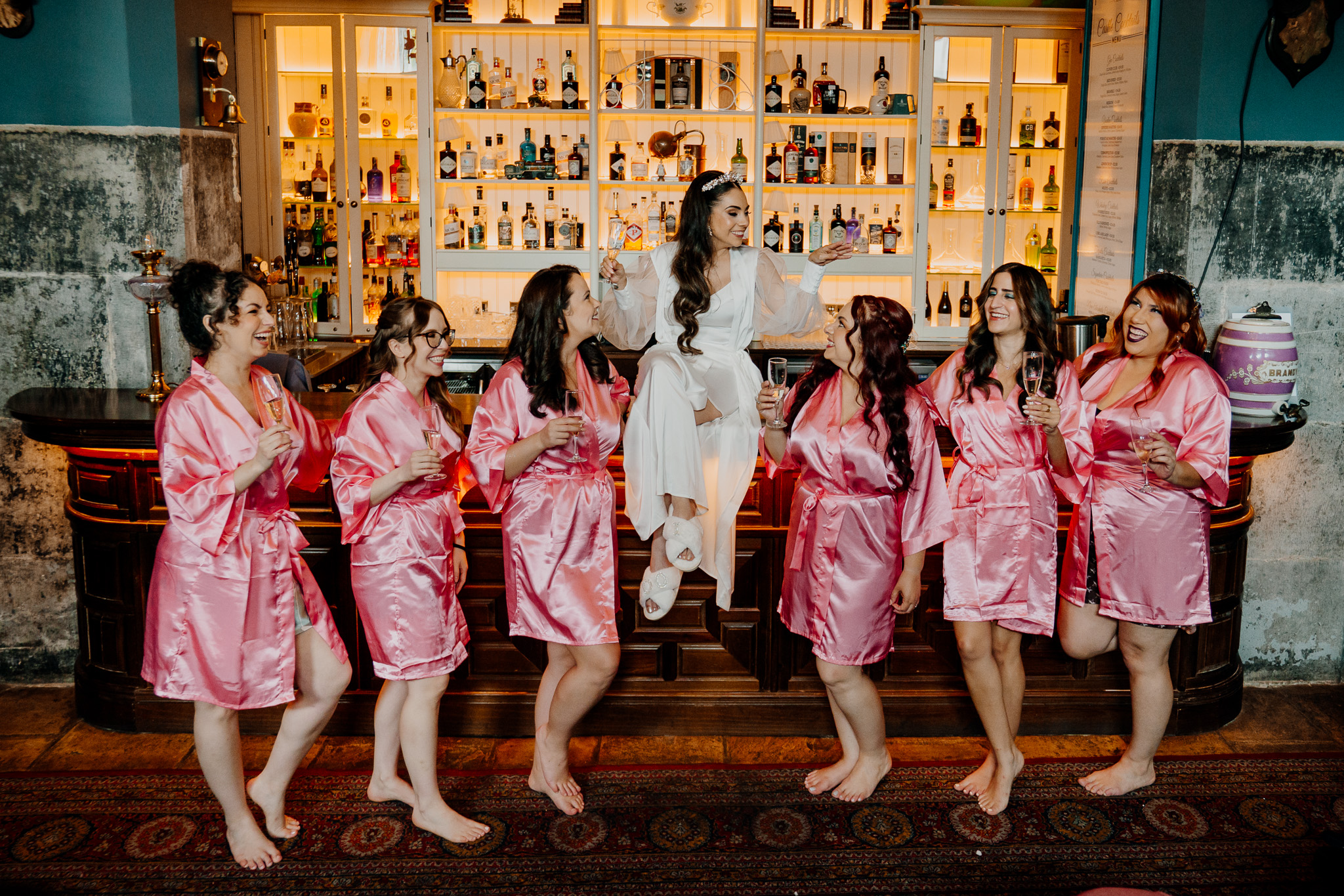 Bridesmaids celebrating in the Gin Bar during wedding preparations at Markree Castle