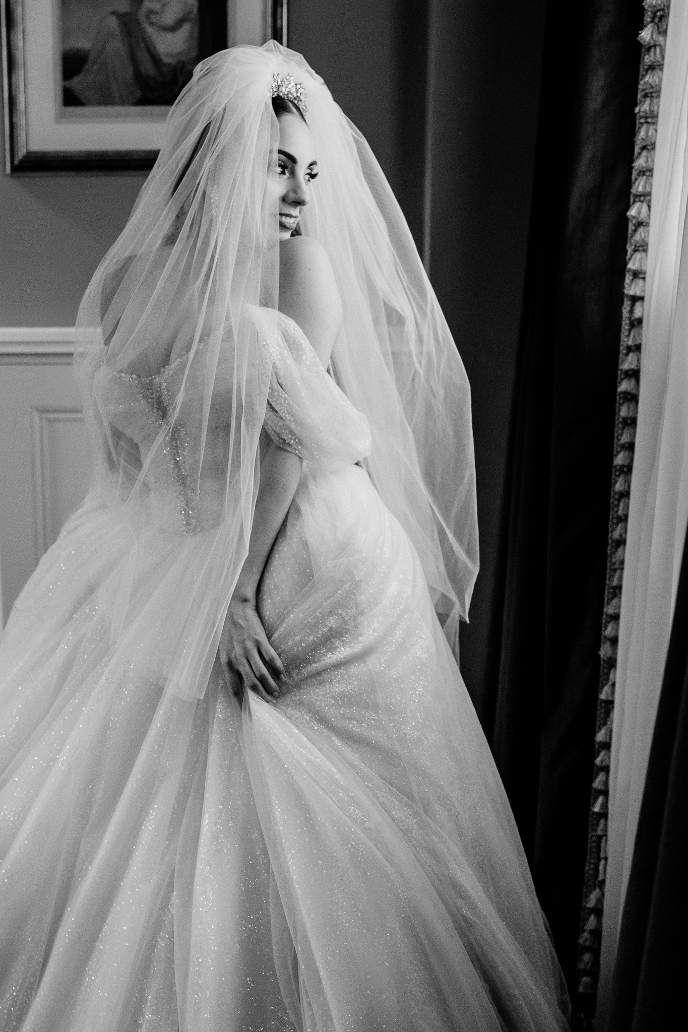 Bride in her wedding dress by a window at Markree Castle