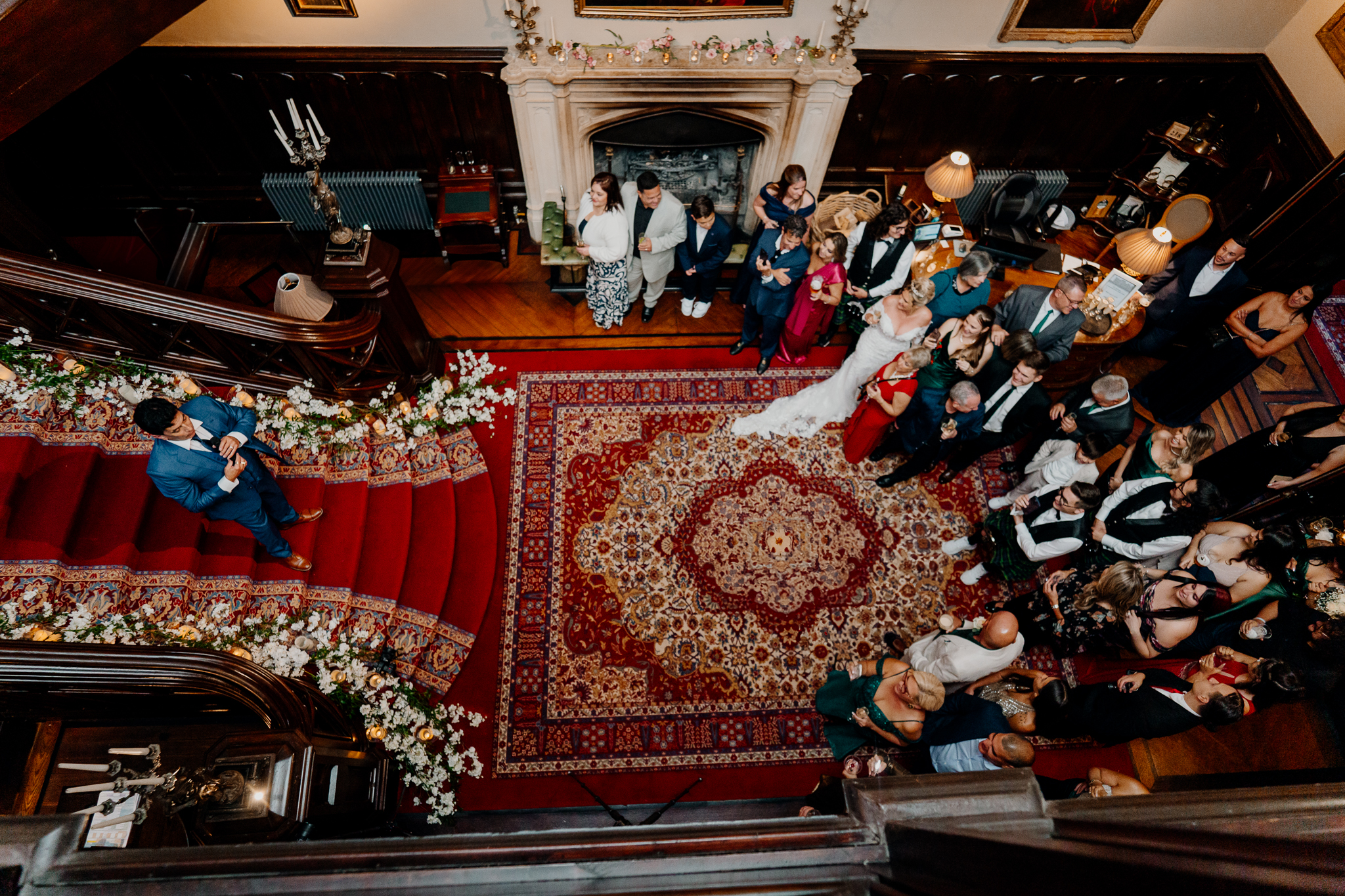 Wedding guests during the reception at Markree Castle, photographed from the gallery above