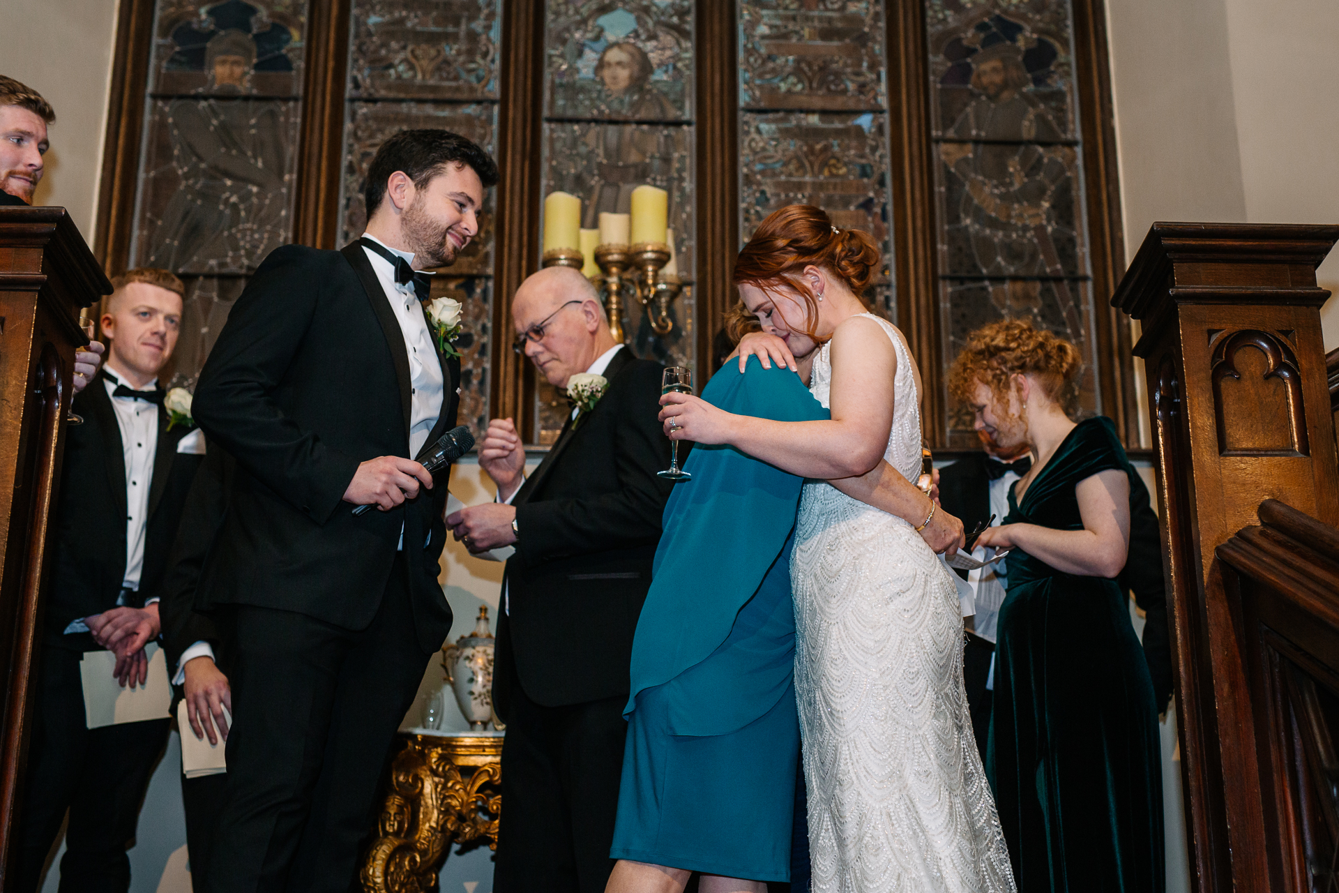 Wedding speeches on the grand staircase of Markree Castle, surrounded by stunning decor and heartfelt emotions.