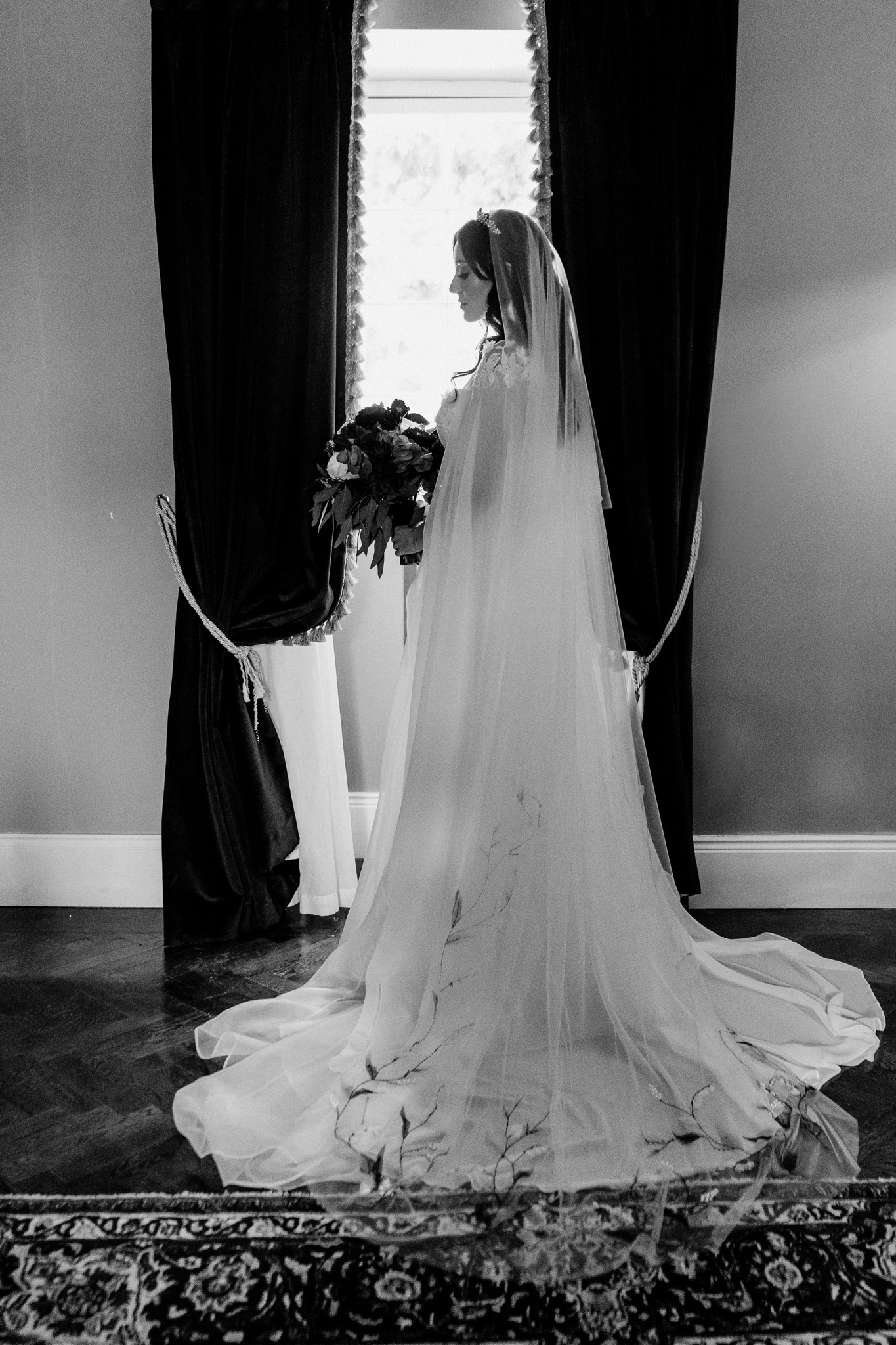 Bride in her wedding dress beside a window in the Bridal Suite at Markree Castle