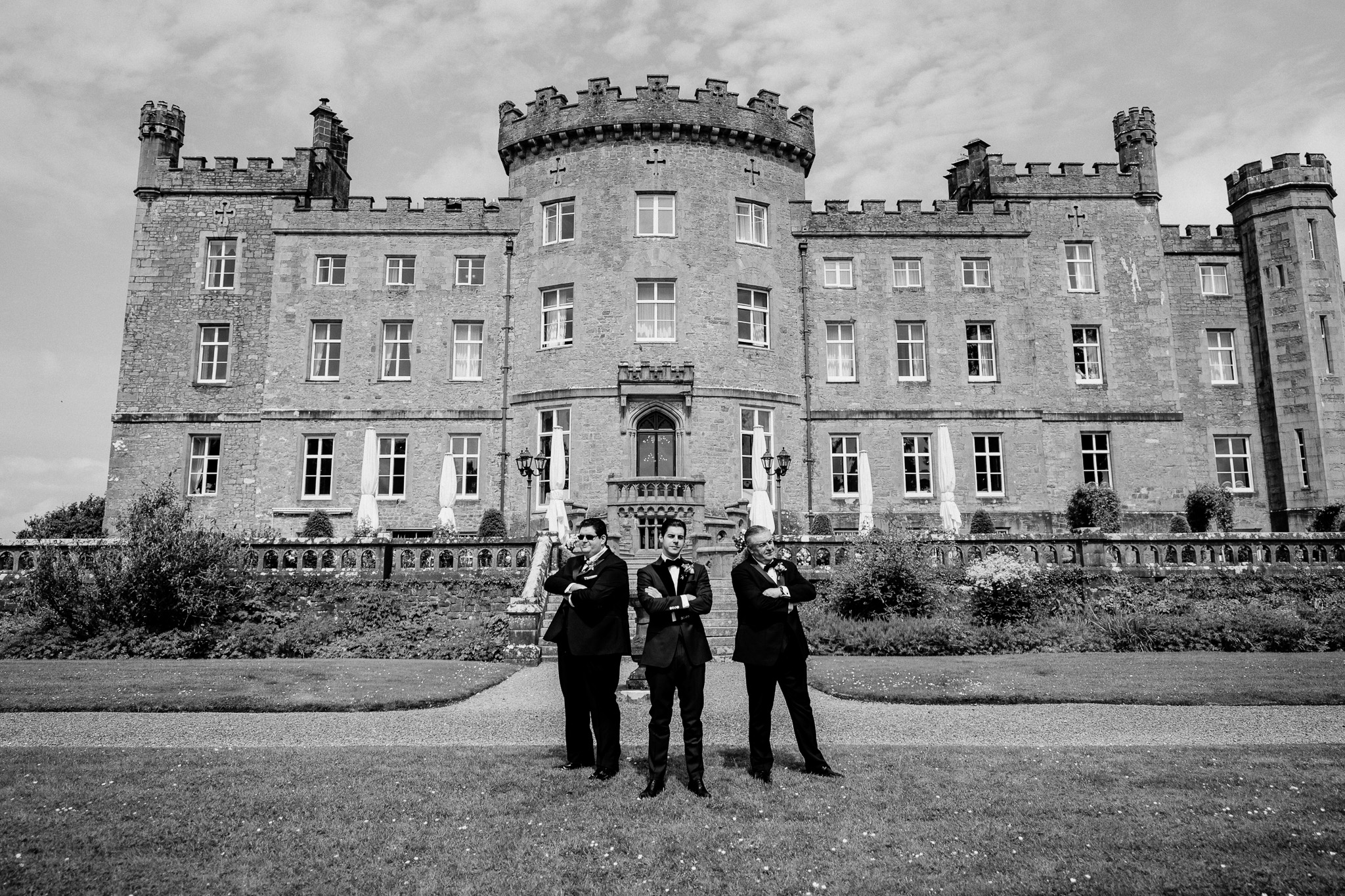 Groom and groomsmen standing in the gardens in front of Markree Castle