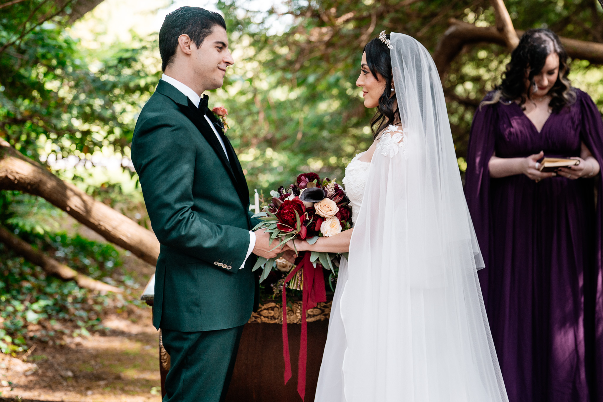 Bride and groom smiling during their woodland wedding ceremony at Markree Castle