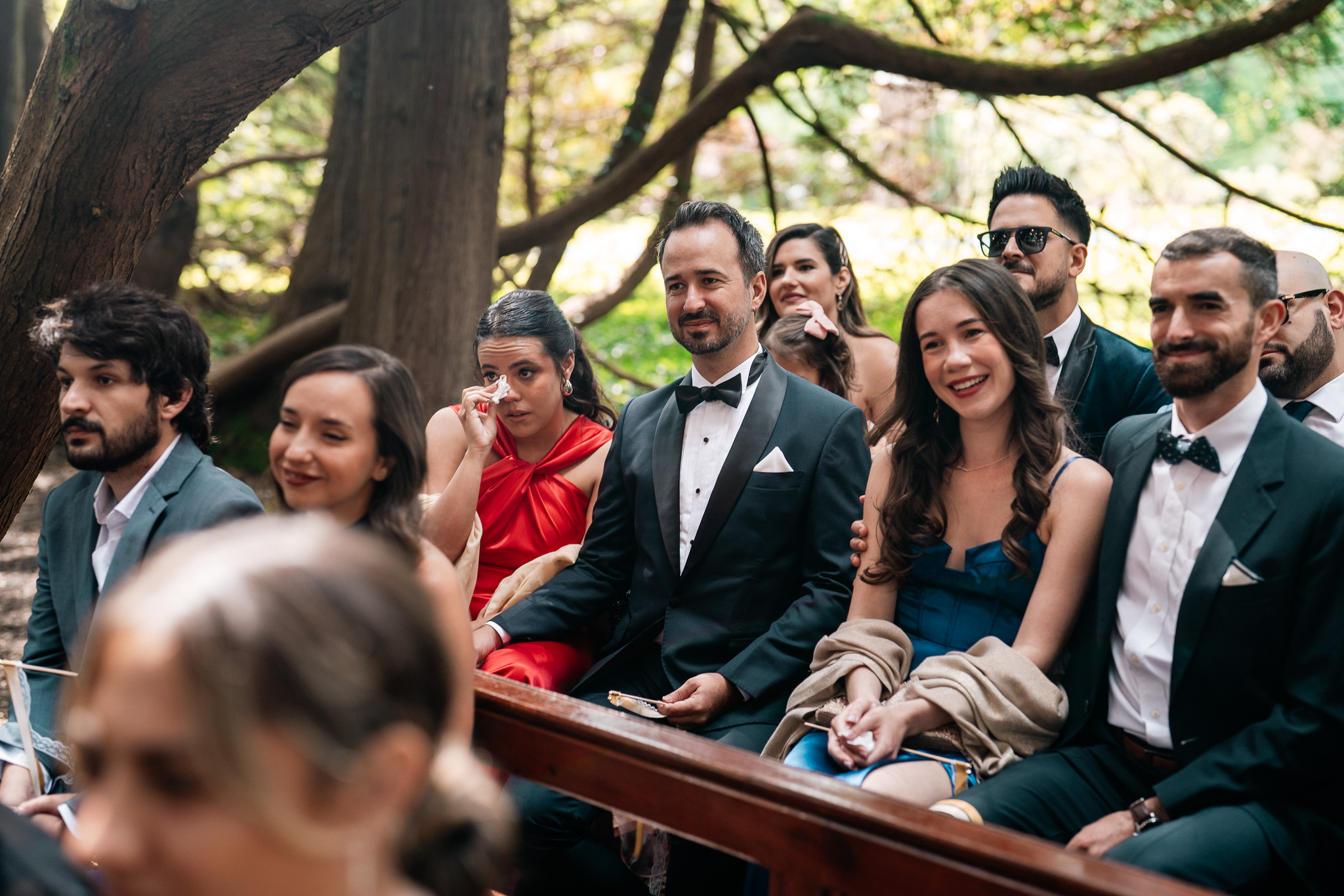 Wedding guests reacting during a woodland ceremony at Markree Castle
