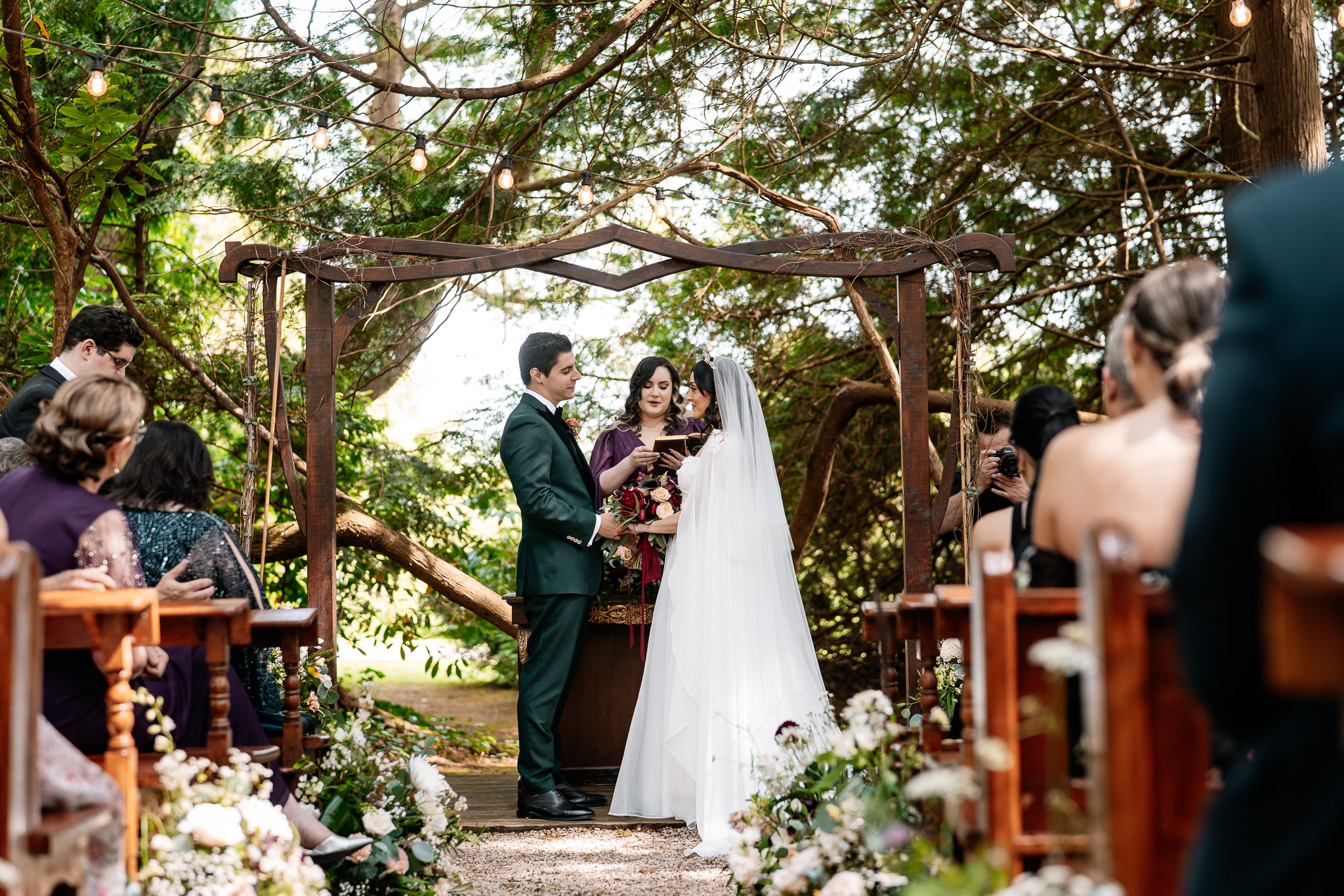 Bride and groom beneath the woodland ceremony arch at Markree Castle