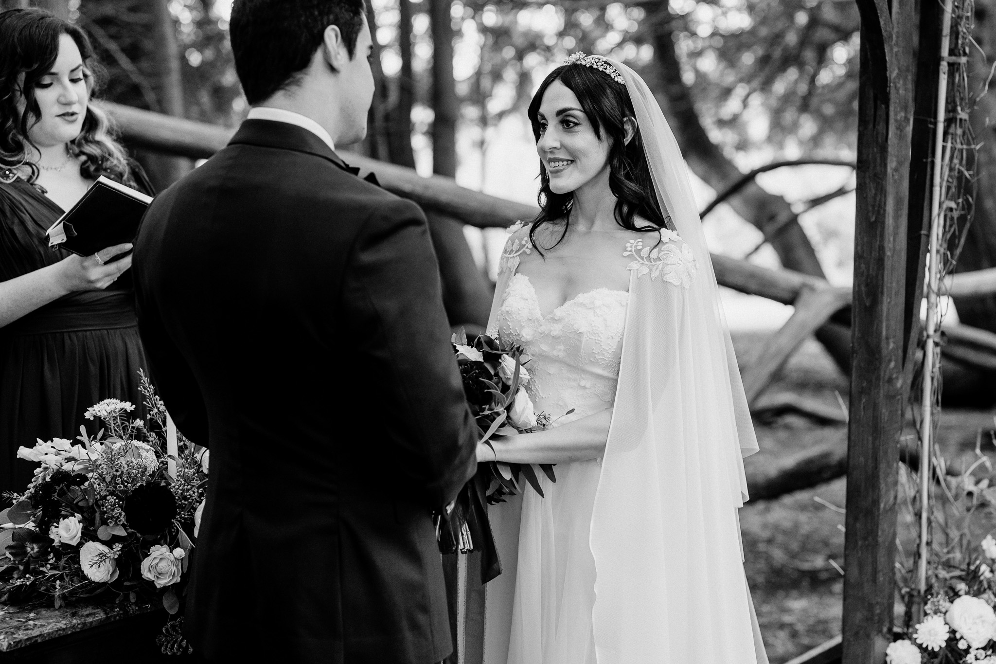 Bride and groom holding hands during their woodland wedding ceremony at Markree Castle
