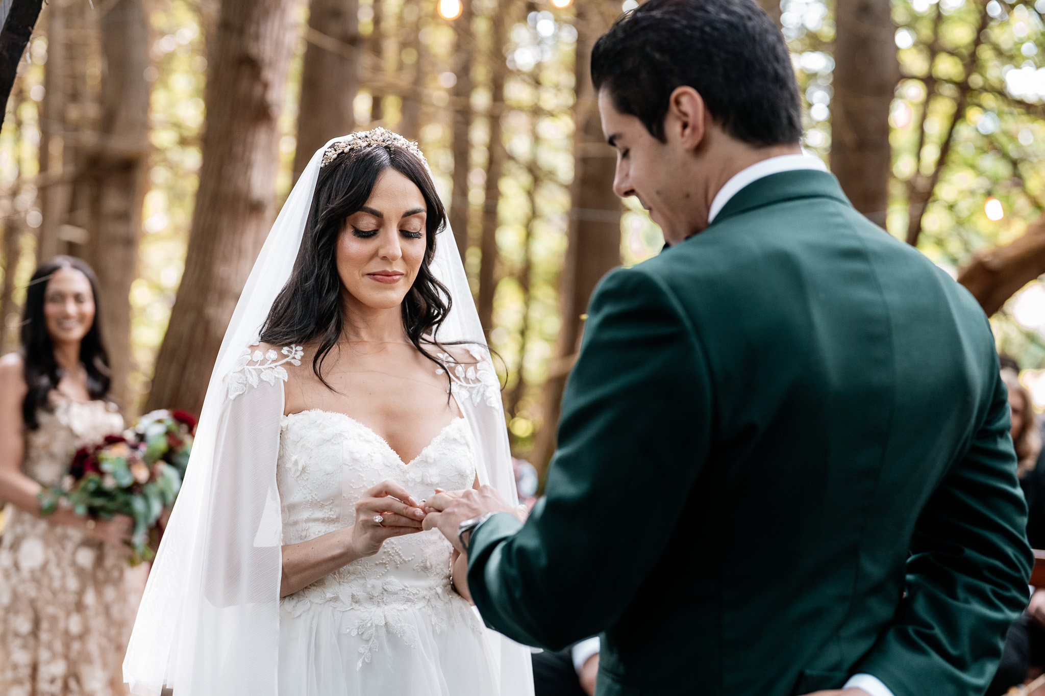 Bride and groom exchanging wedding rings during a woodland ceremony at Markree Castle